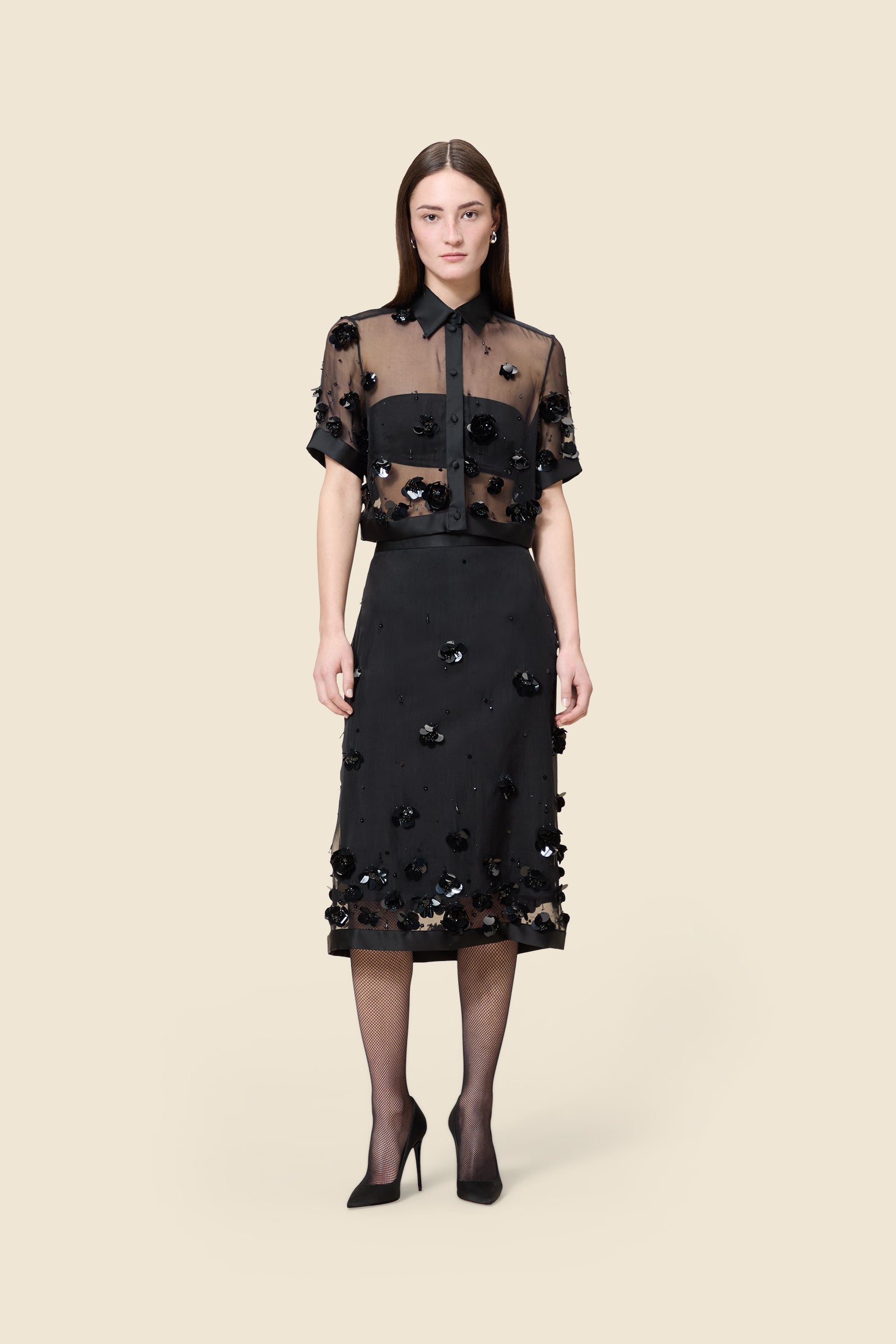 With hand-applied paillettes and crystals on silk organza featuring the satin edges, the skirt transforms classic floral embroidery into a modern piece