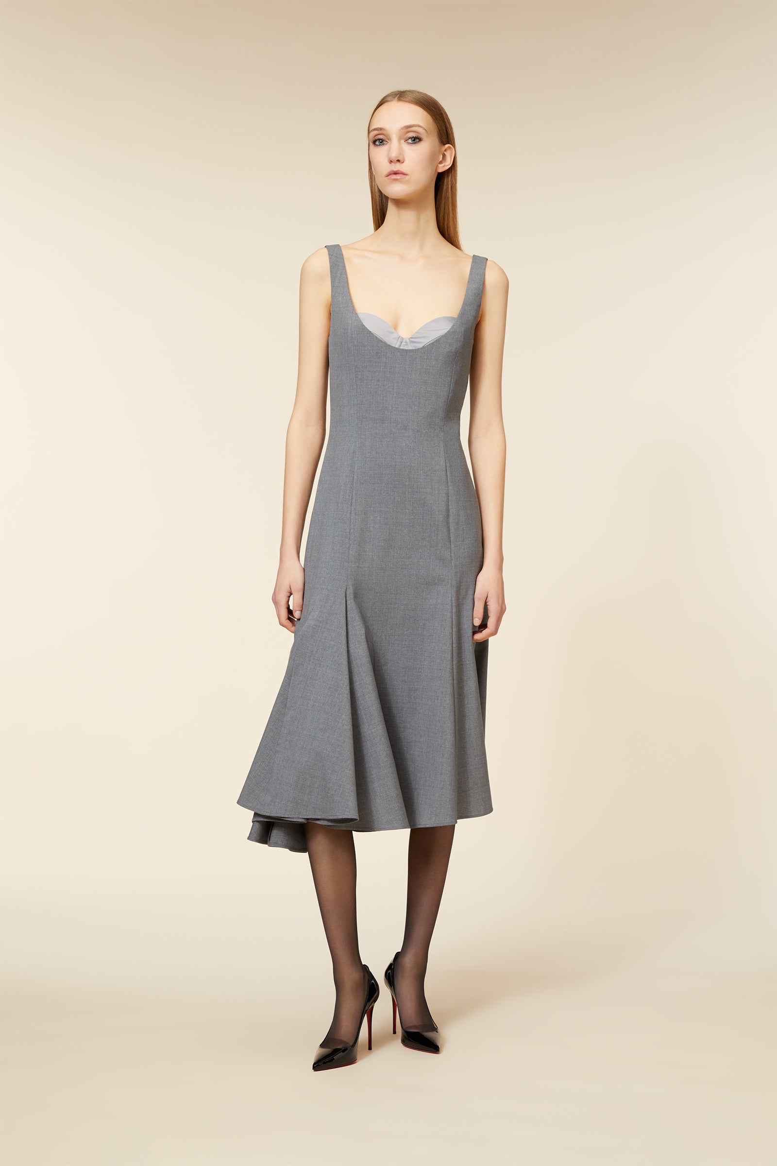 Gray midi dress with a flared asymmetrical hem, featuring wide shoulder straps and a subtle sweetheart neckline.