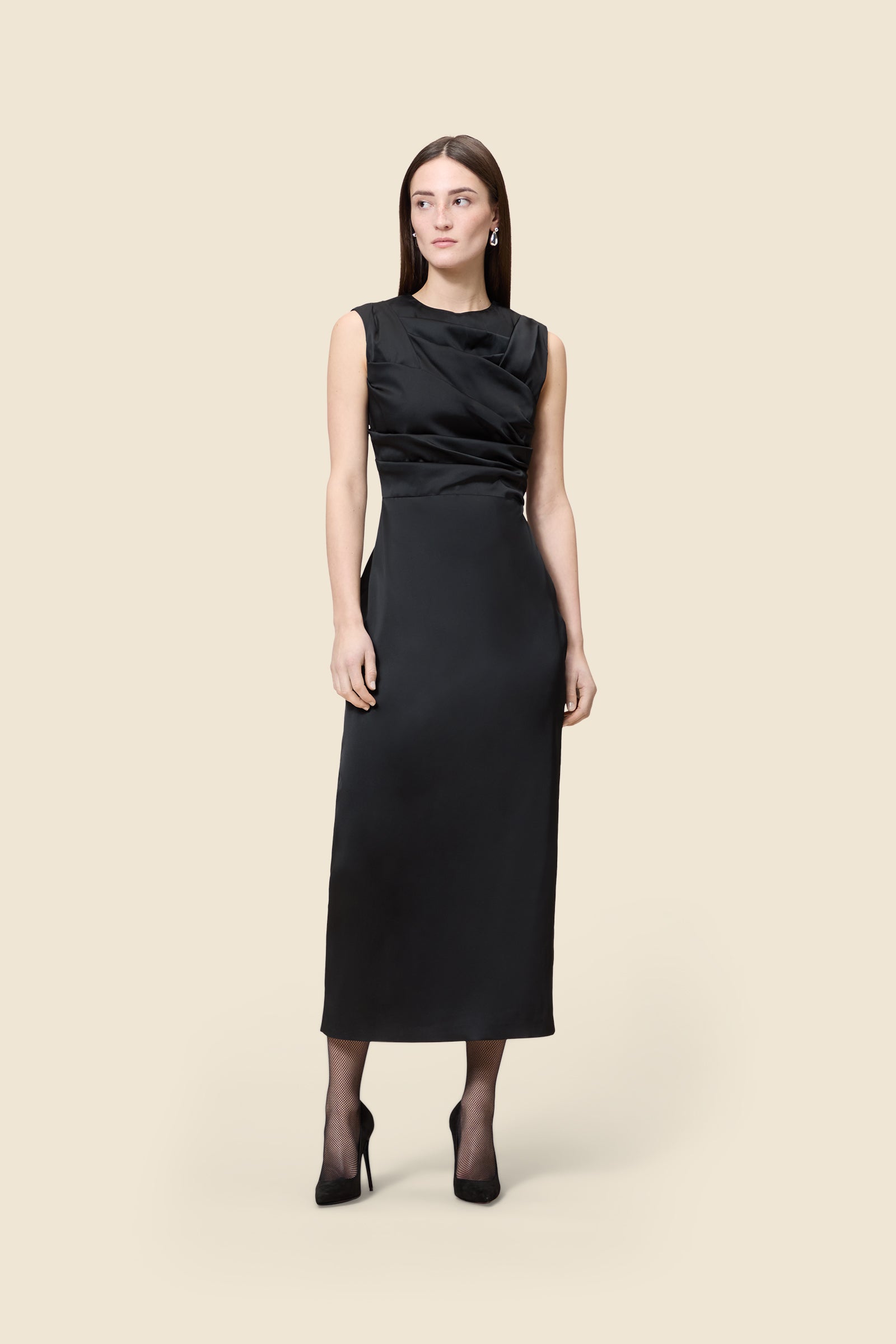 The meticulously placed pleats and stretch satin define the elegance of the dress, reflecting classic haute couture craftsmanship with a modern edge