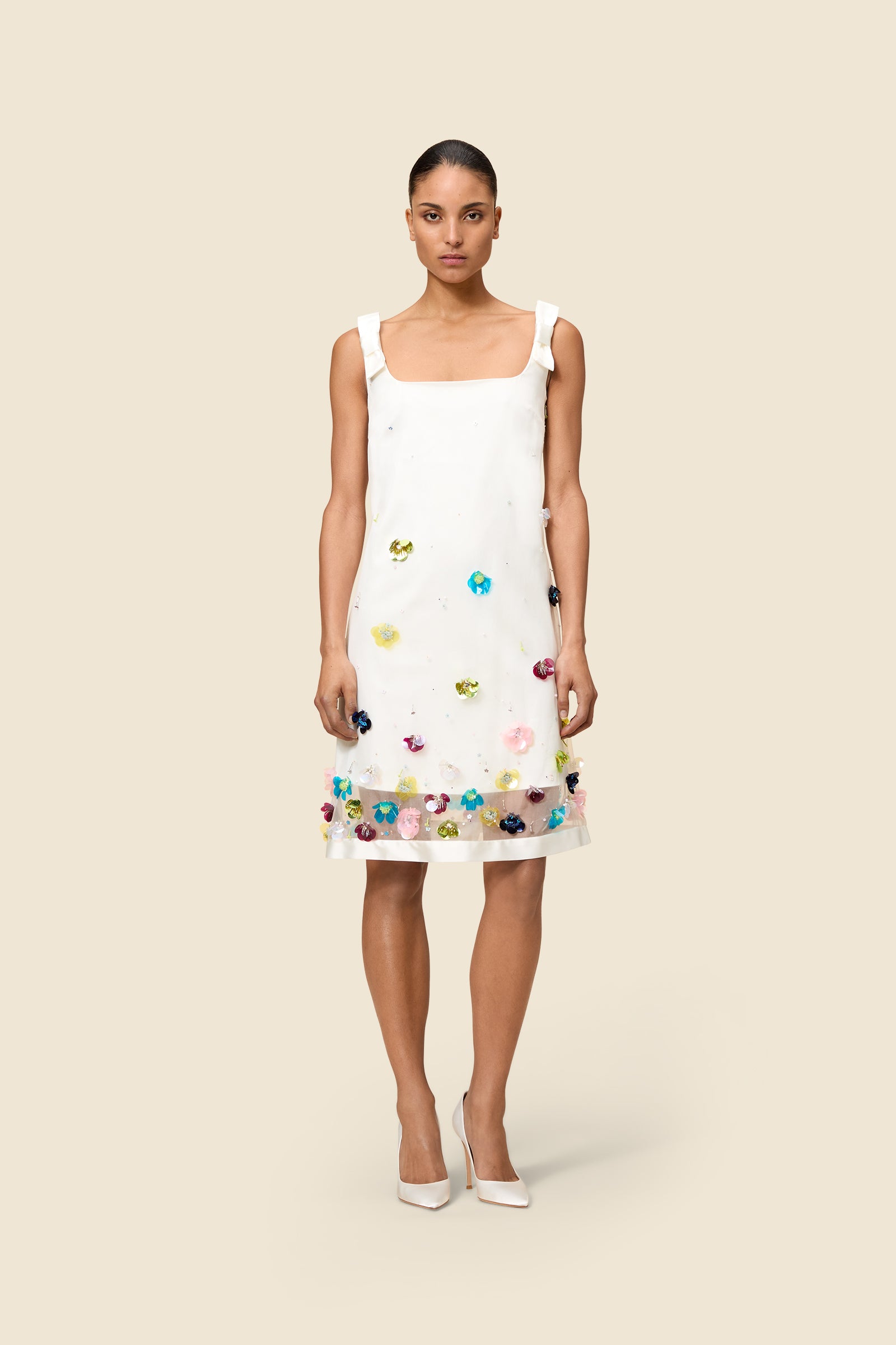 With hand-applied paillettes and crystals on silk organza featuring the satin edges, the dress transforms classic floral embroidery into a modern piece