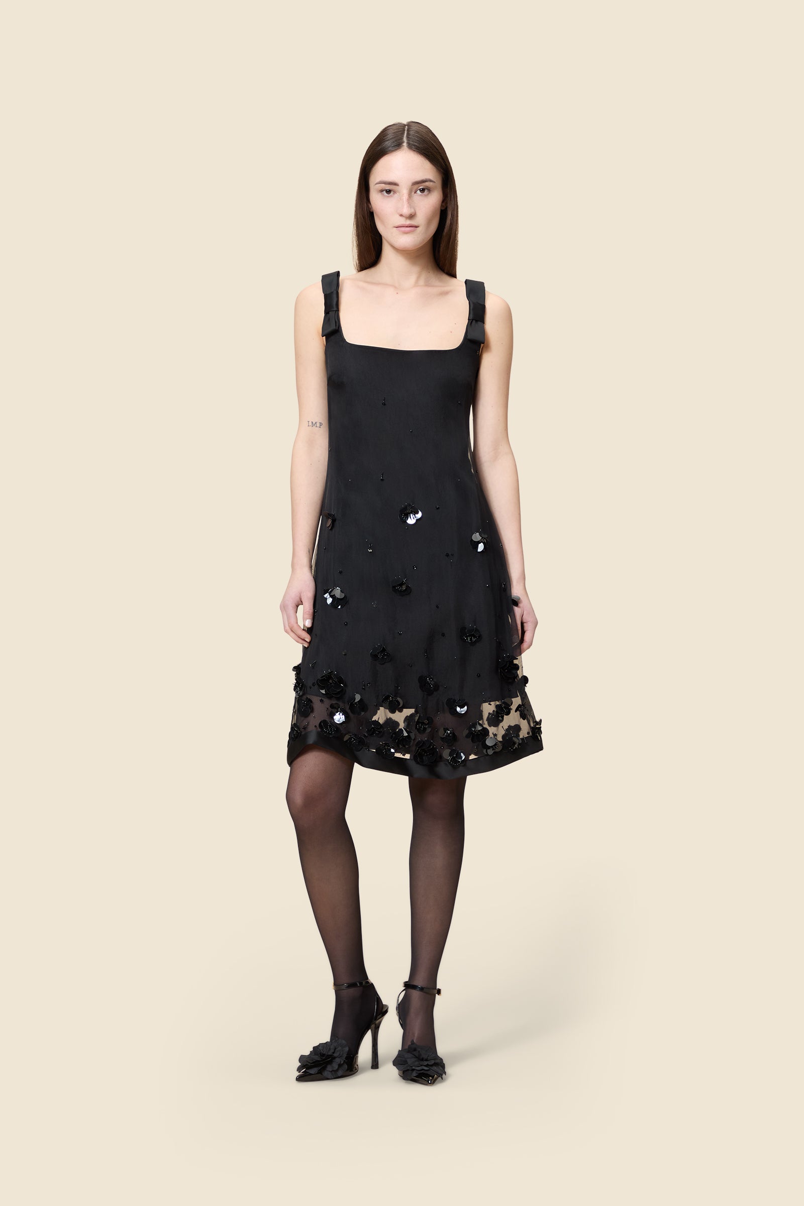 With hand-applied paillettes and crystals on silk organza featuring the satin edges, the dress transforms classic floral embroidery into a modern piece