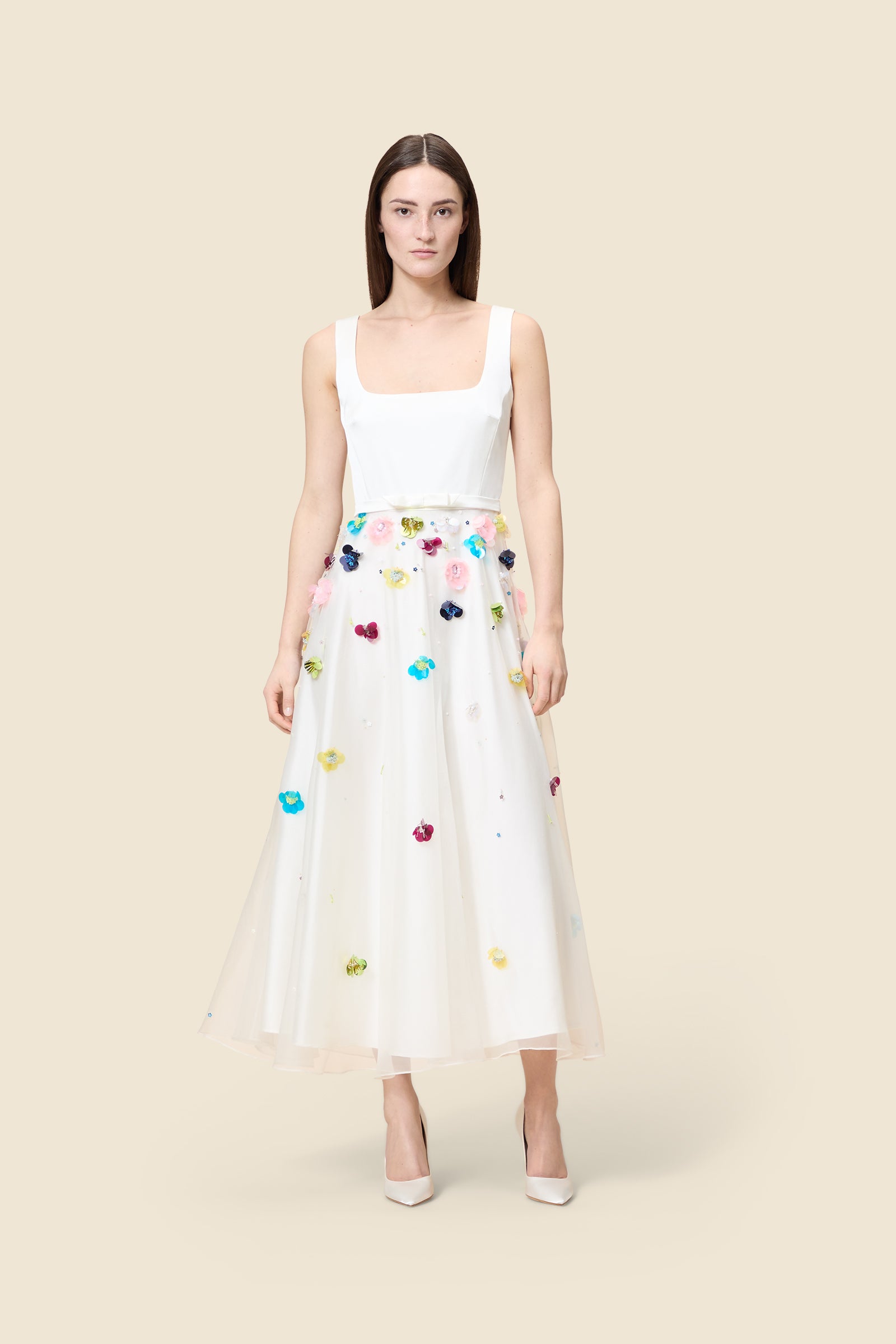 With hand-applied paillettes and crystals on silk organza featuring the satin edges, the dress transforms classic floral embroidery into a modern piece