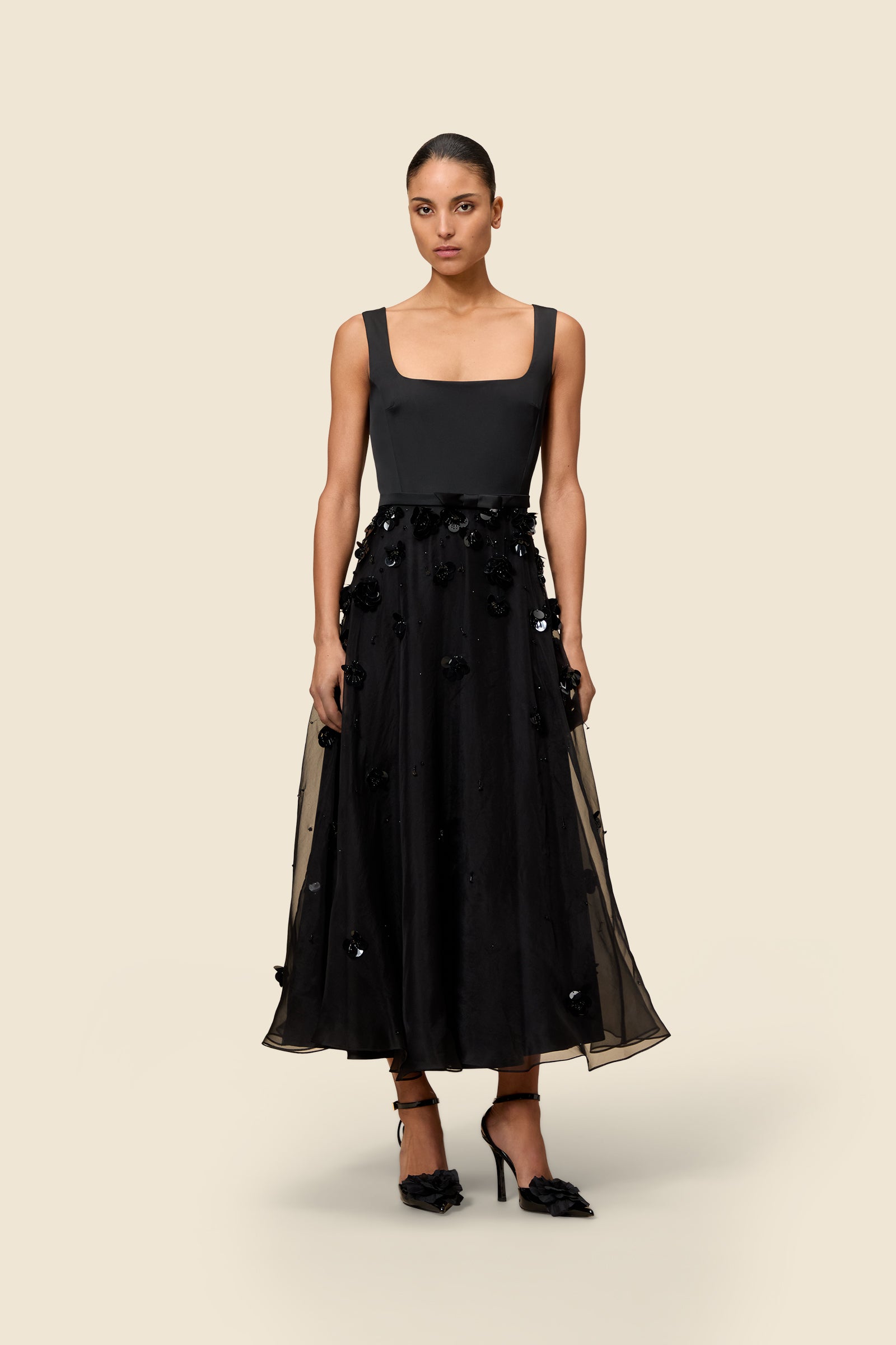 With hand-applied paillettes and crystals on silk organza featuring the satin edges, the dress transforms classic floral embroidery into a modern piece