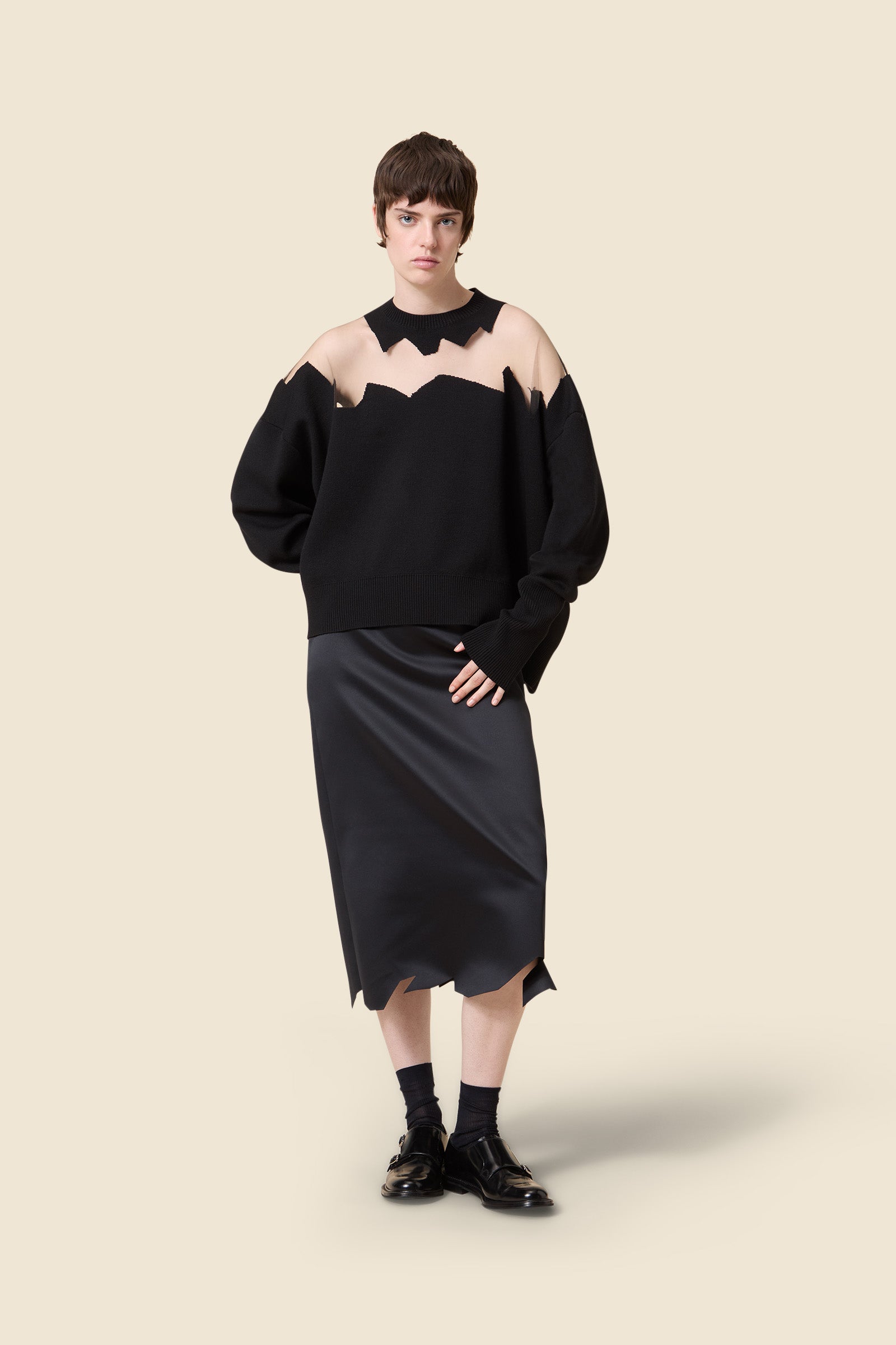 The knitwear, inspired by viktor&rolf's scissorhands, is crafted with 100% merino wool and showcases intricate holes knitted with transparent yarn in a jacquard technique