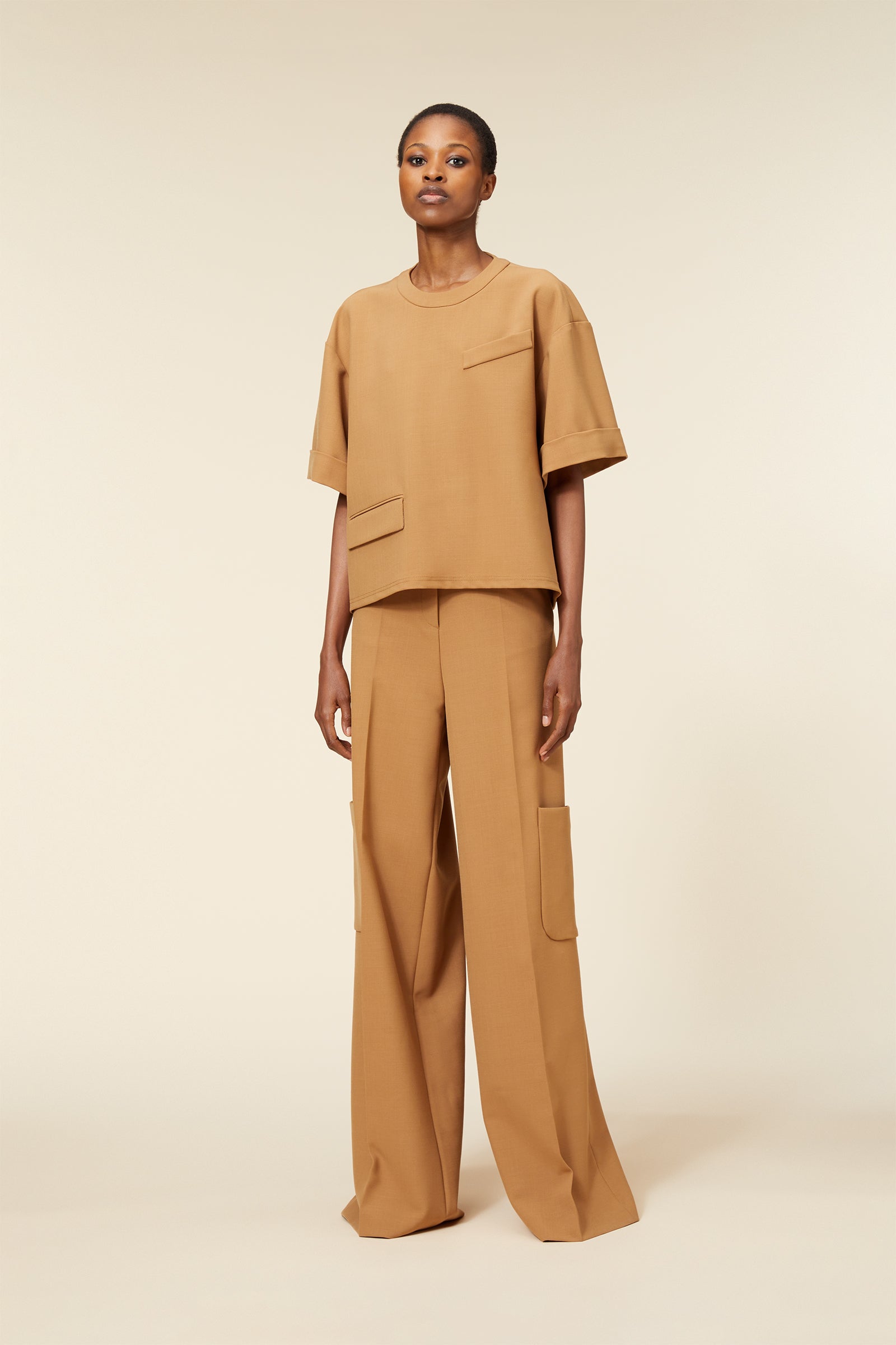 Wide-leg camel trousers paired with a matching oversized camel shirt, featuring minimalistic pocket detailing.