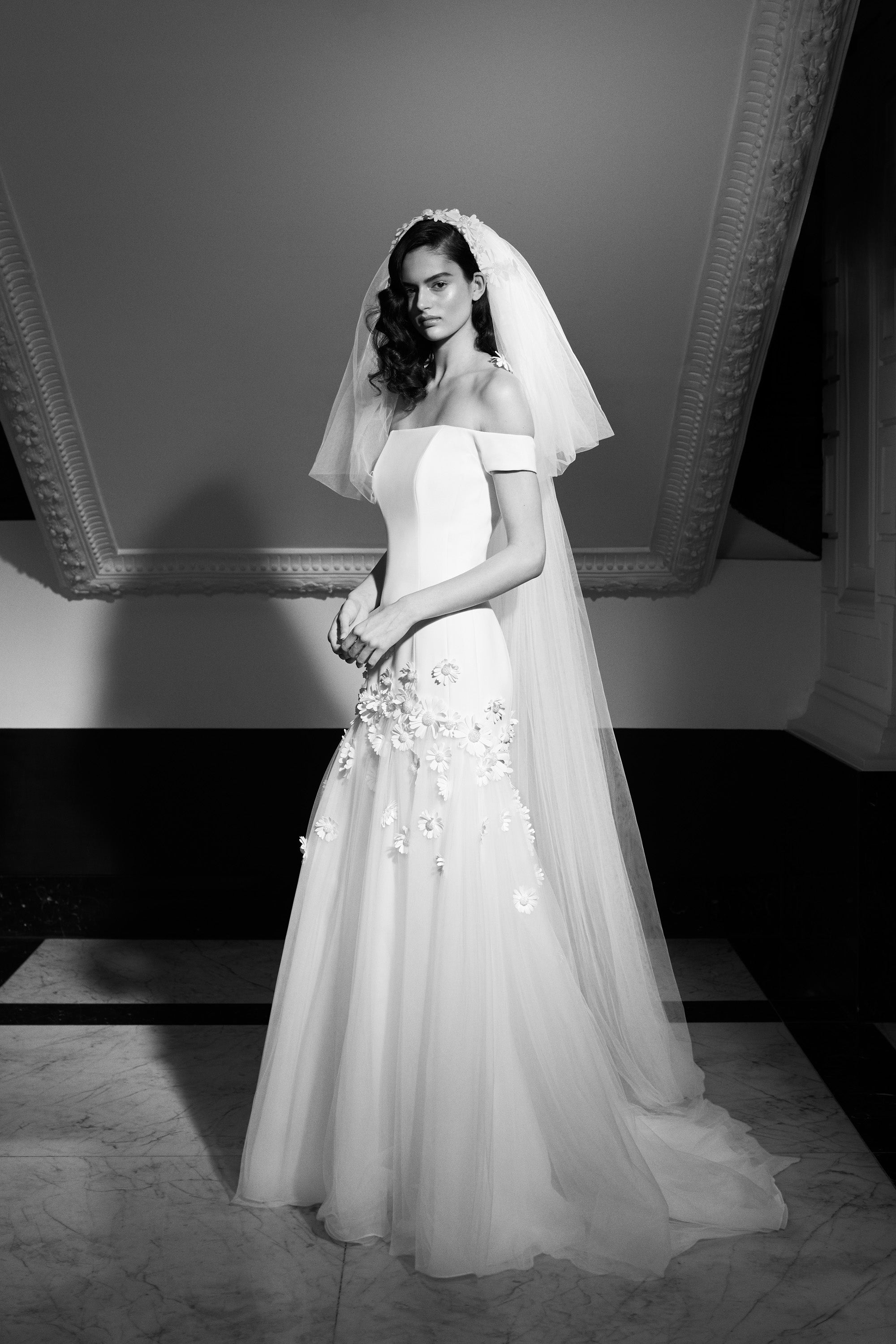 Elegant Viktor & Rolf Mariage bridal gown, off-shoulder design with floral appliqués and flowing veil, couture style.