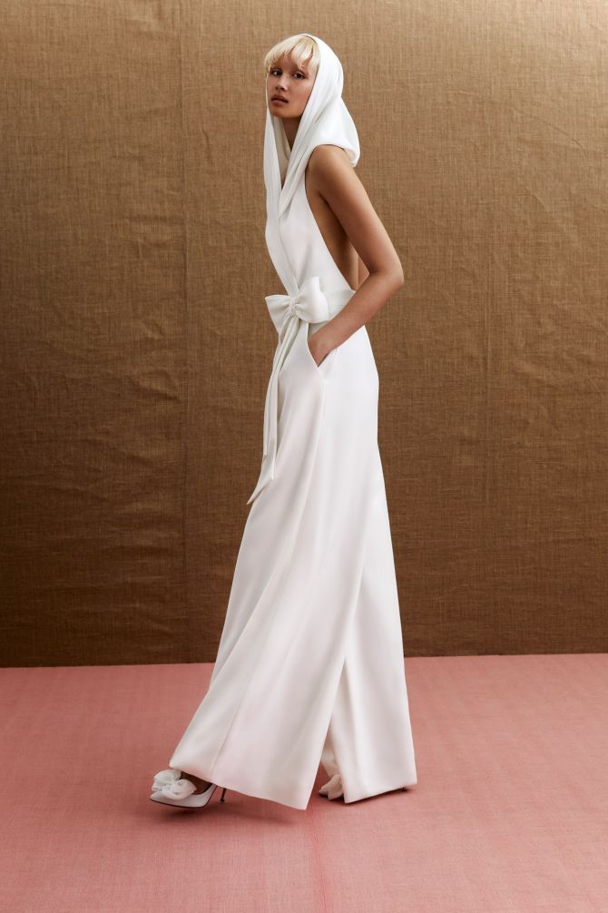 Viktor & Rolf Mariage Bridalwear Collection featuring Statement Kylie Jumpsuit, elegant design with hood and bow detail.