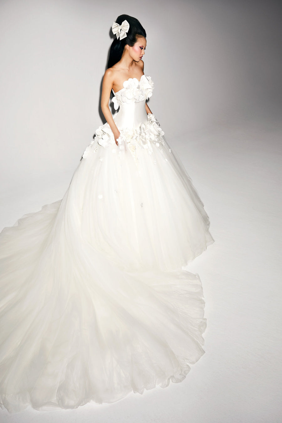 Sophisticated ballgown adorned with mikado ‘abundance fantaisie’ flowers and couture bows edged around the strapless bodice