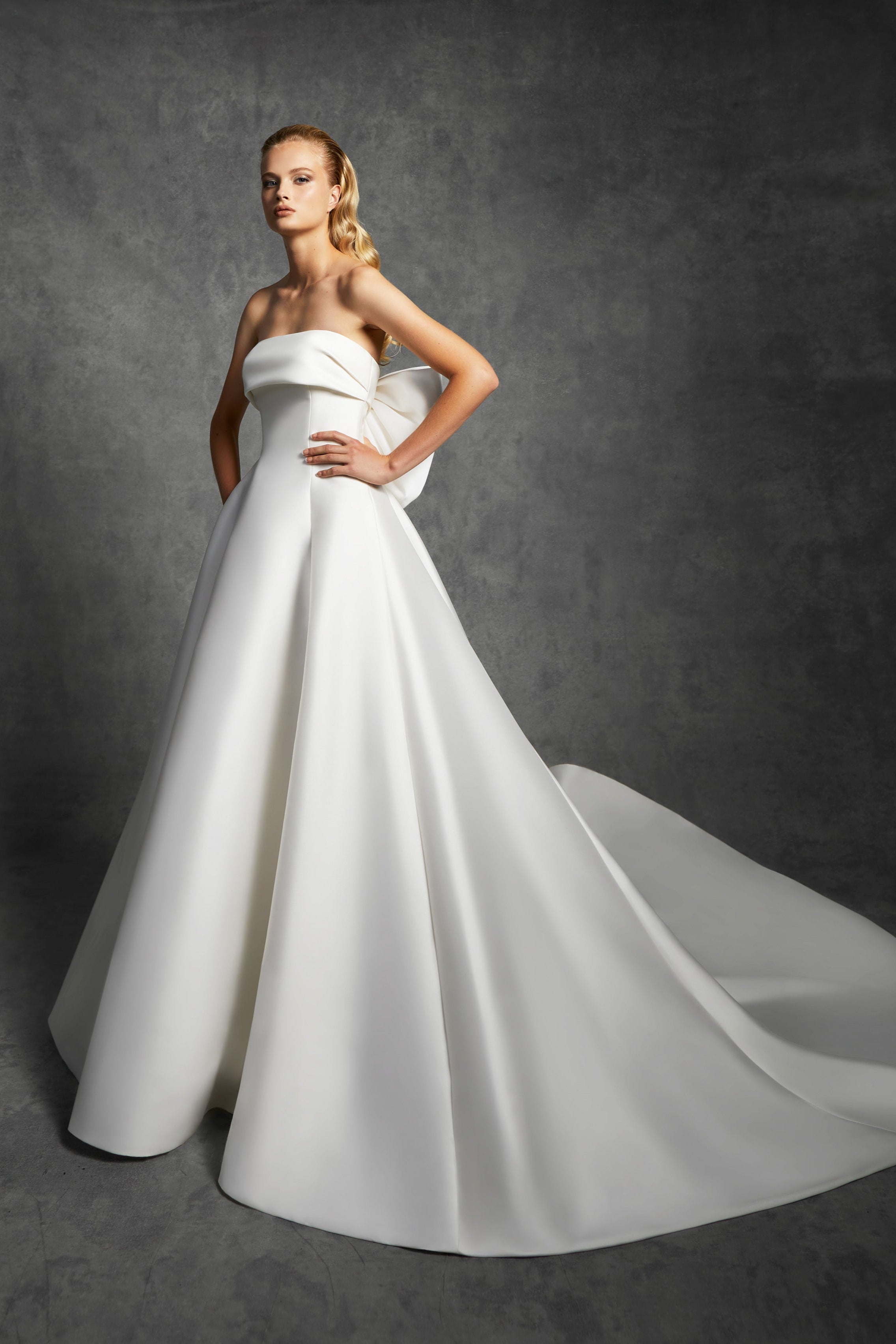 Graphic, strapless a-line dress with a clean band that leads way to an oversized signature viktor&rolf bow to create back interest