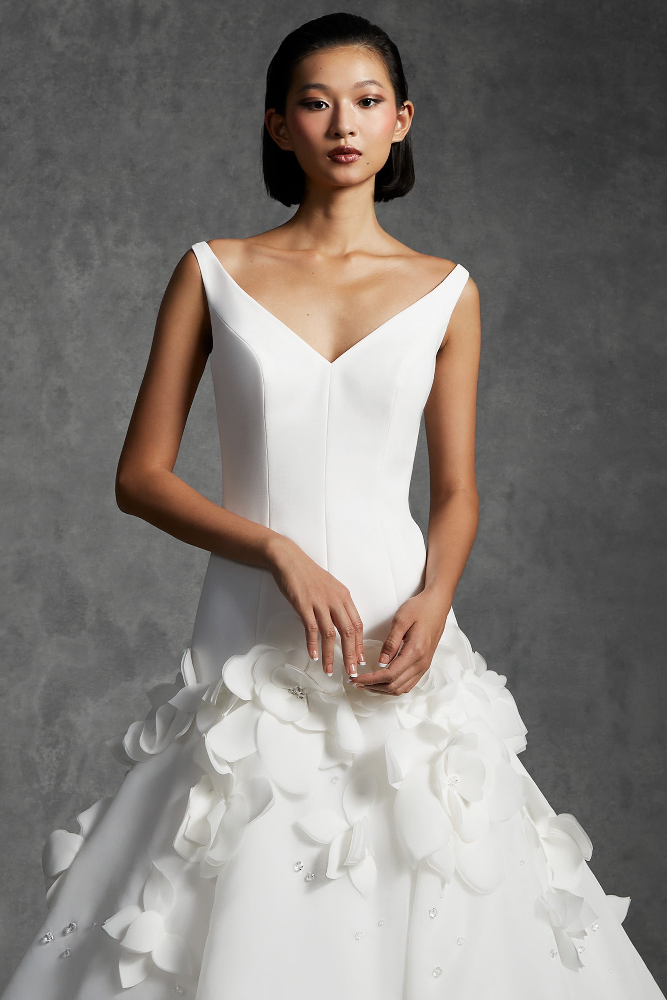 Chic mermaid silhouette with a clean crepe bodice that delicately sculpts the wearer's body