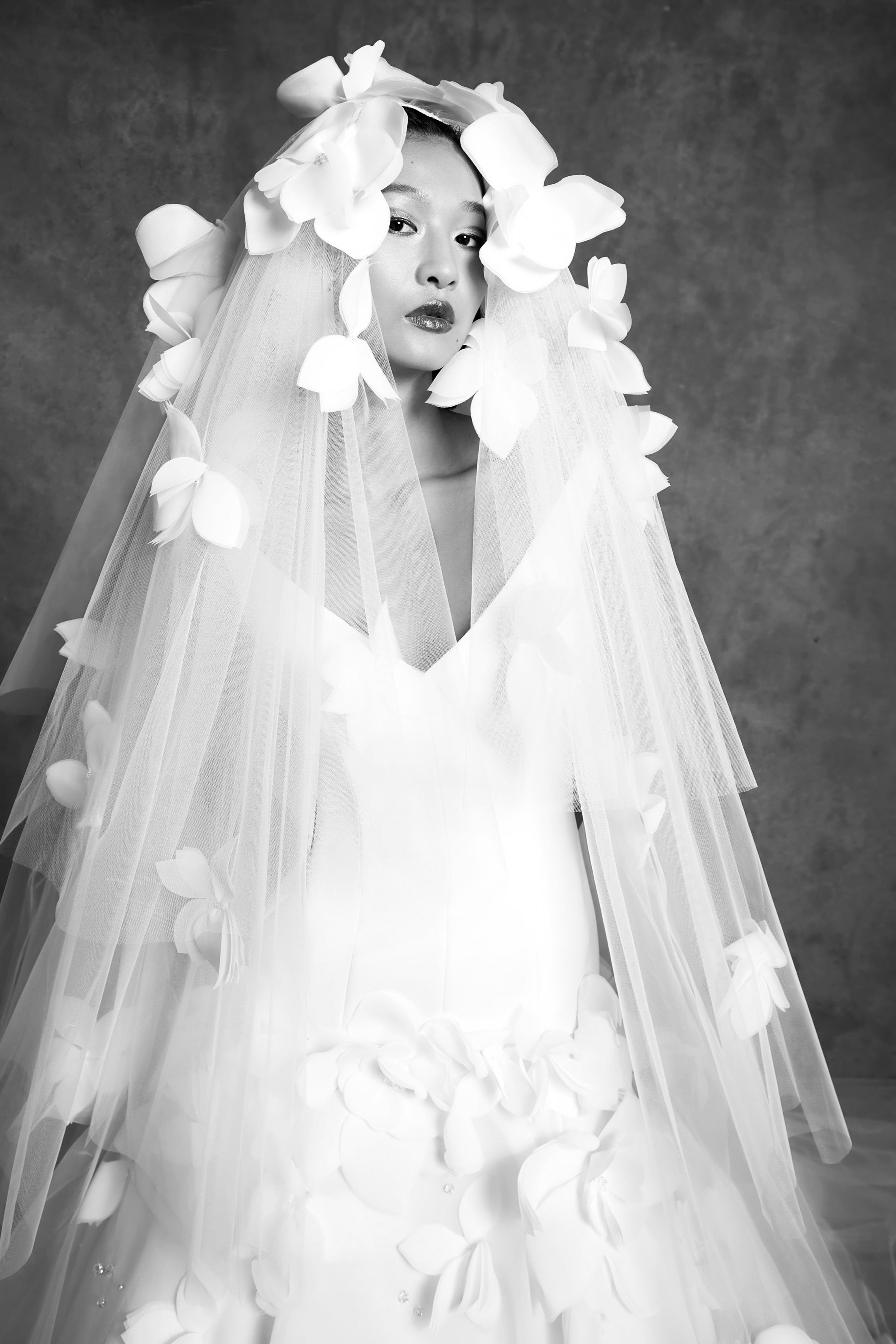 Tulle veil adorned with feathered airy organza flowers cascading down the sheer veil