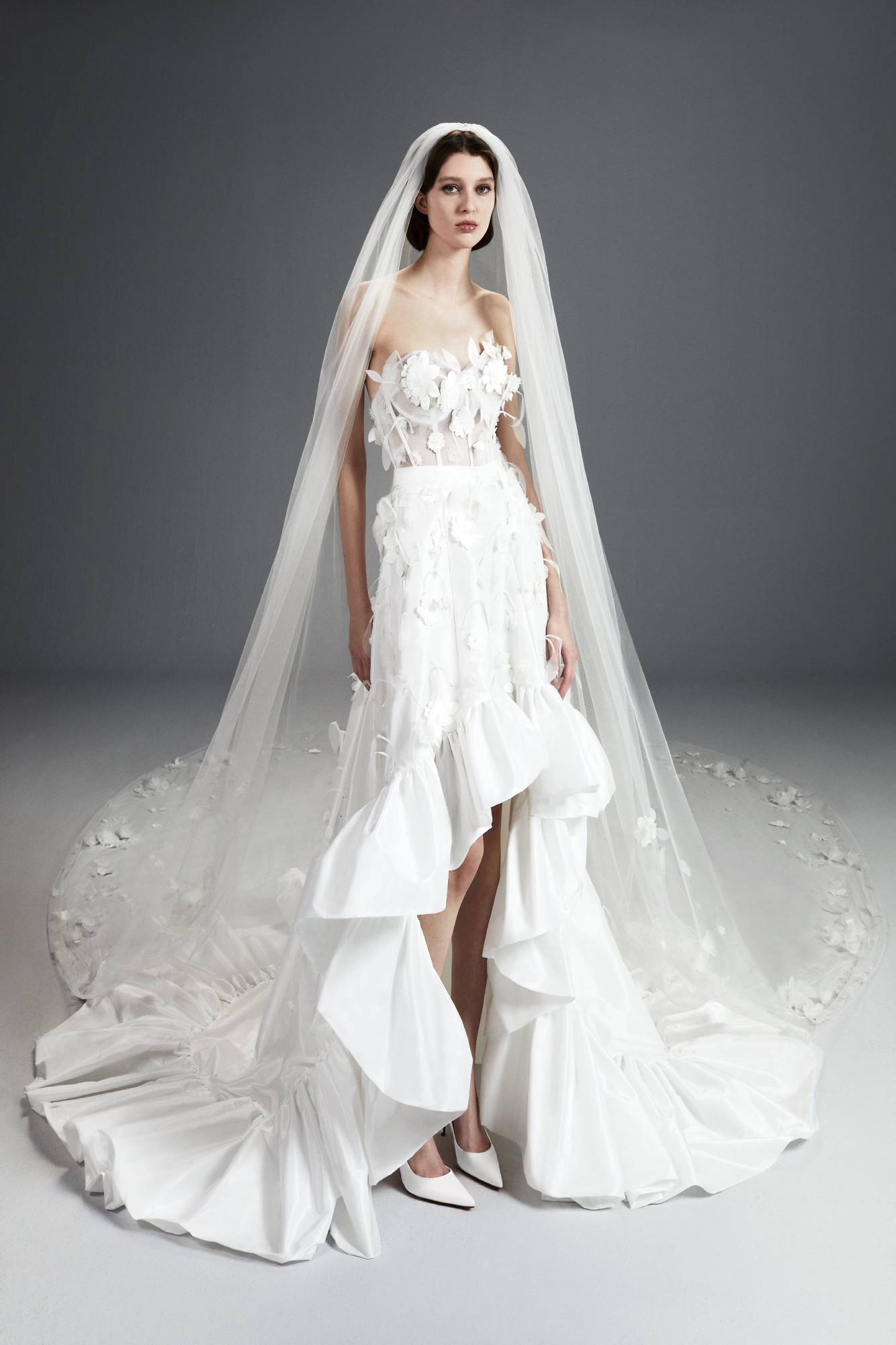 Viktor & Rolf Mariage Collection, floral applique bridal gown with layered ruffles and delicate veil detailing for elegance.