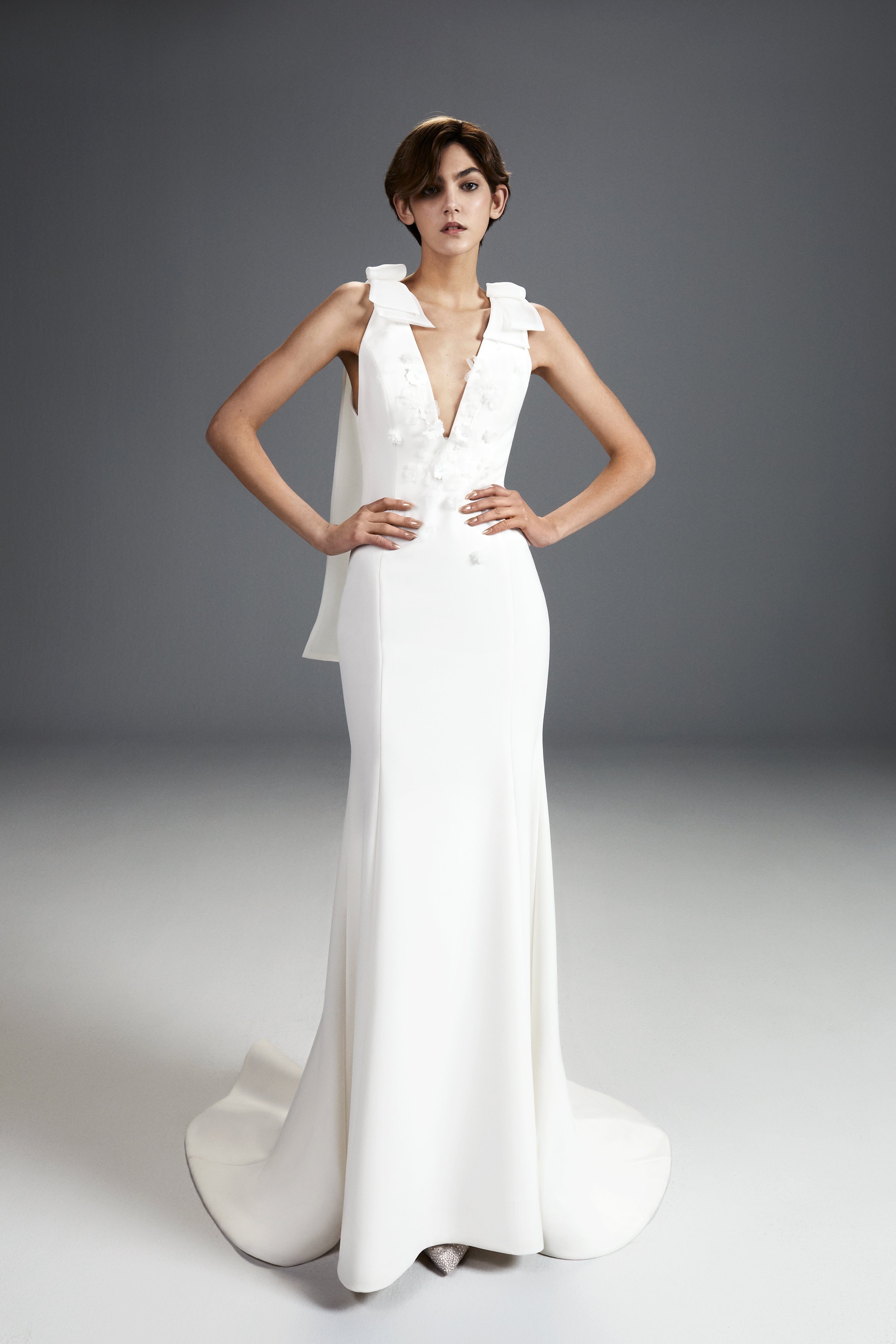 Viktor & Rolf Mariage Bridalwear Collection Fairytale Flowers gown; sleek white design with intricate floral accents.