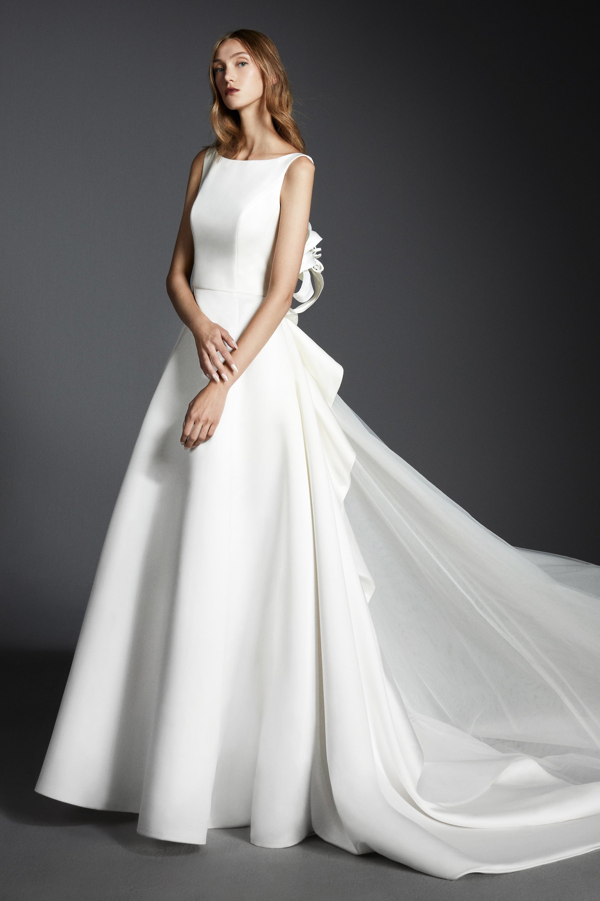 Elegant and timeless, this a-line satin gown boasts a clean boat neck