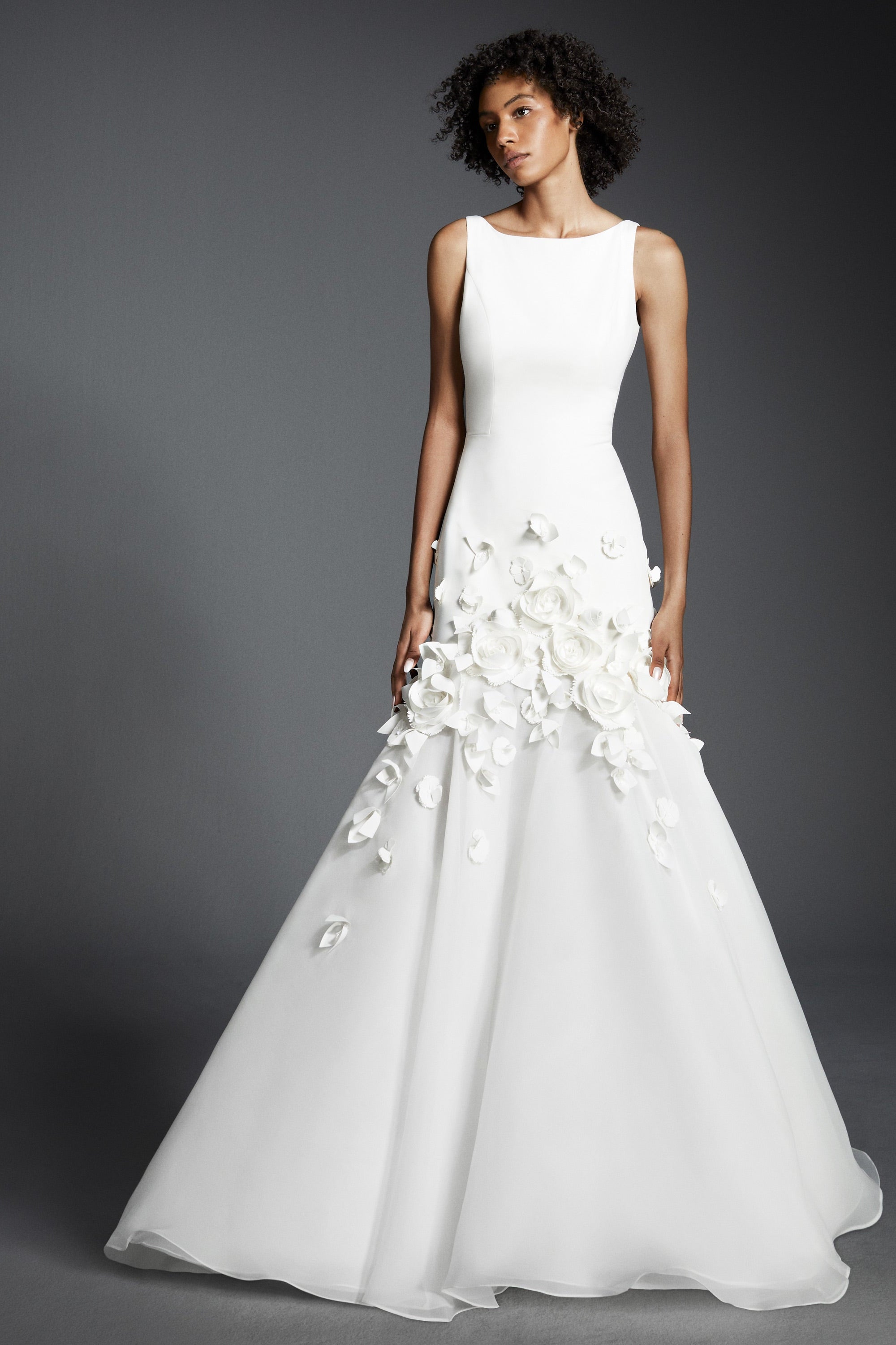 This refined mermaid gown, crafted from crepe with a slight stretch, perfectly molds to the wearer’s body before flaring out into a decadent train