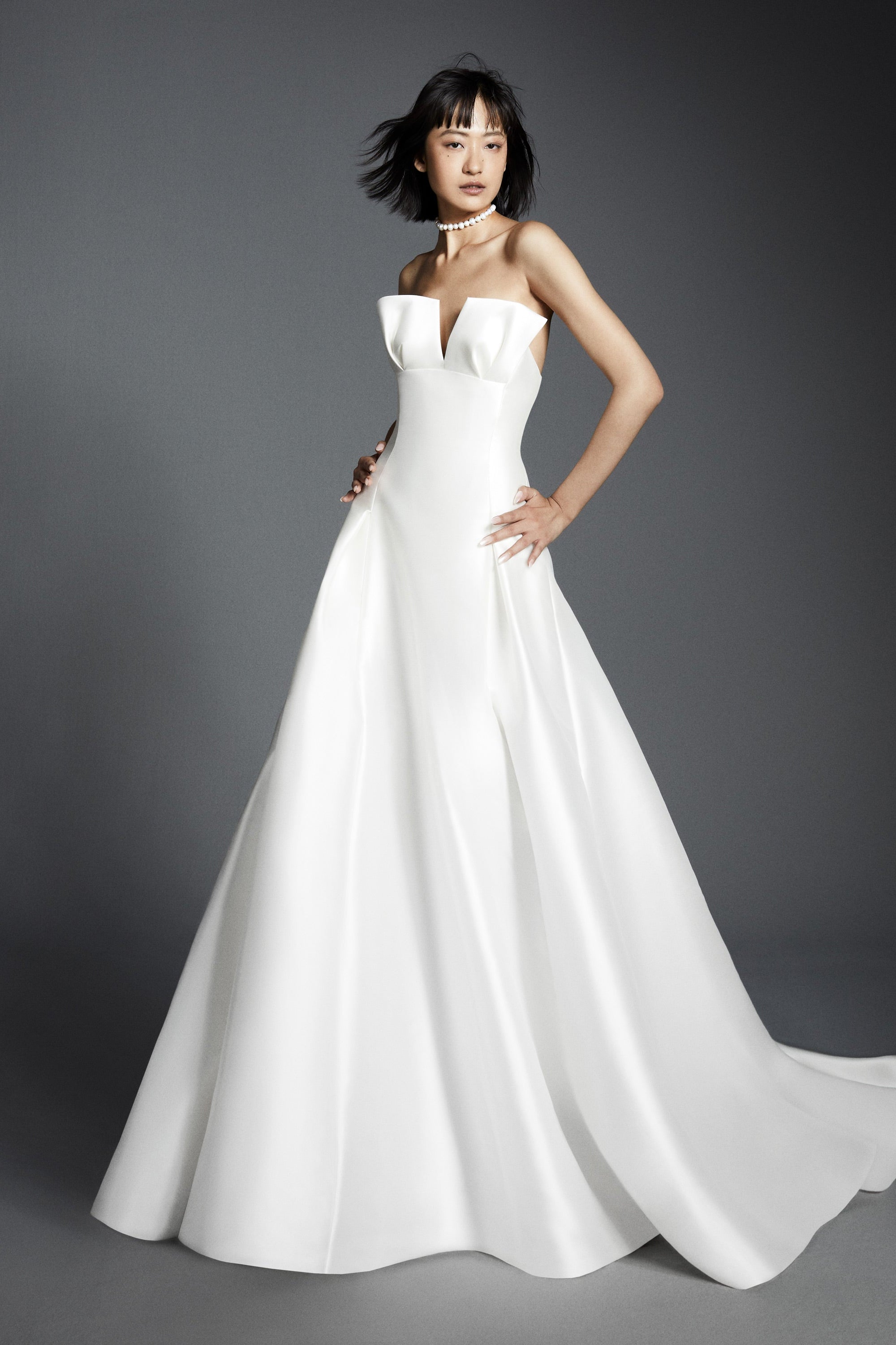 Chic a-line gown crafted out of mikado, perfectly molds to the body and flares out in a decadent train