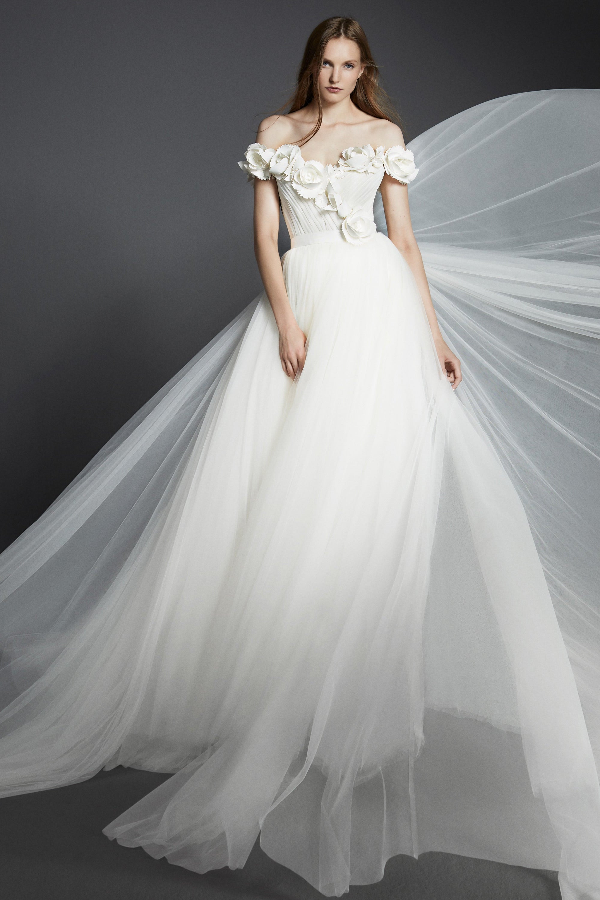 Dreamy tulle a-line gown featuring a bodice adorned with delicate garden flowers crafted from crepe