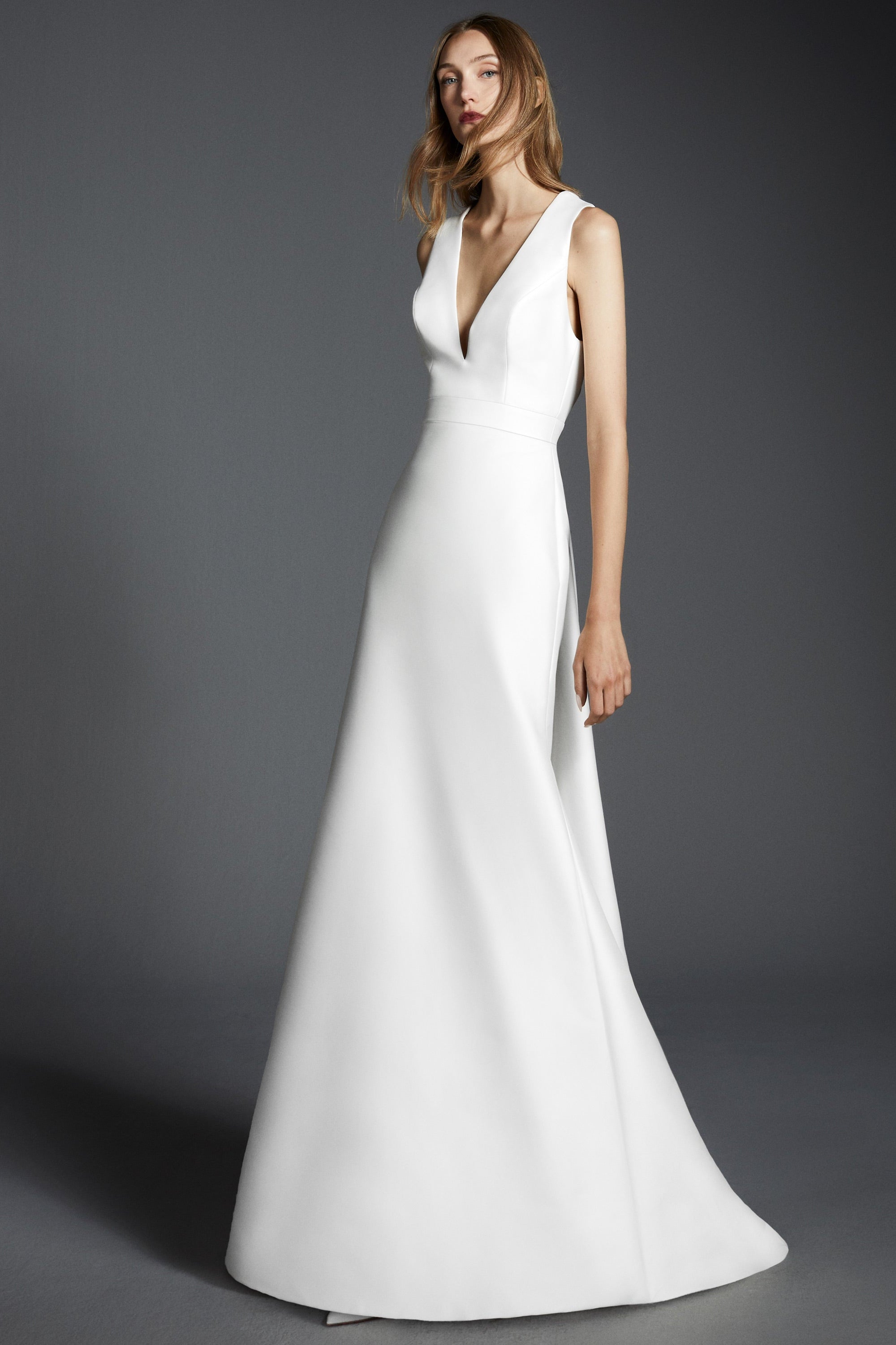 Chic mermaid gown crafted out of mikado with a slight stretch, featuring an elegant plunging v-neckline