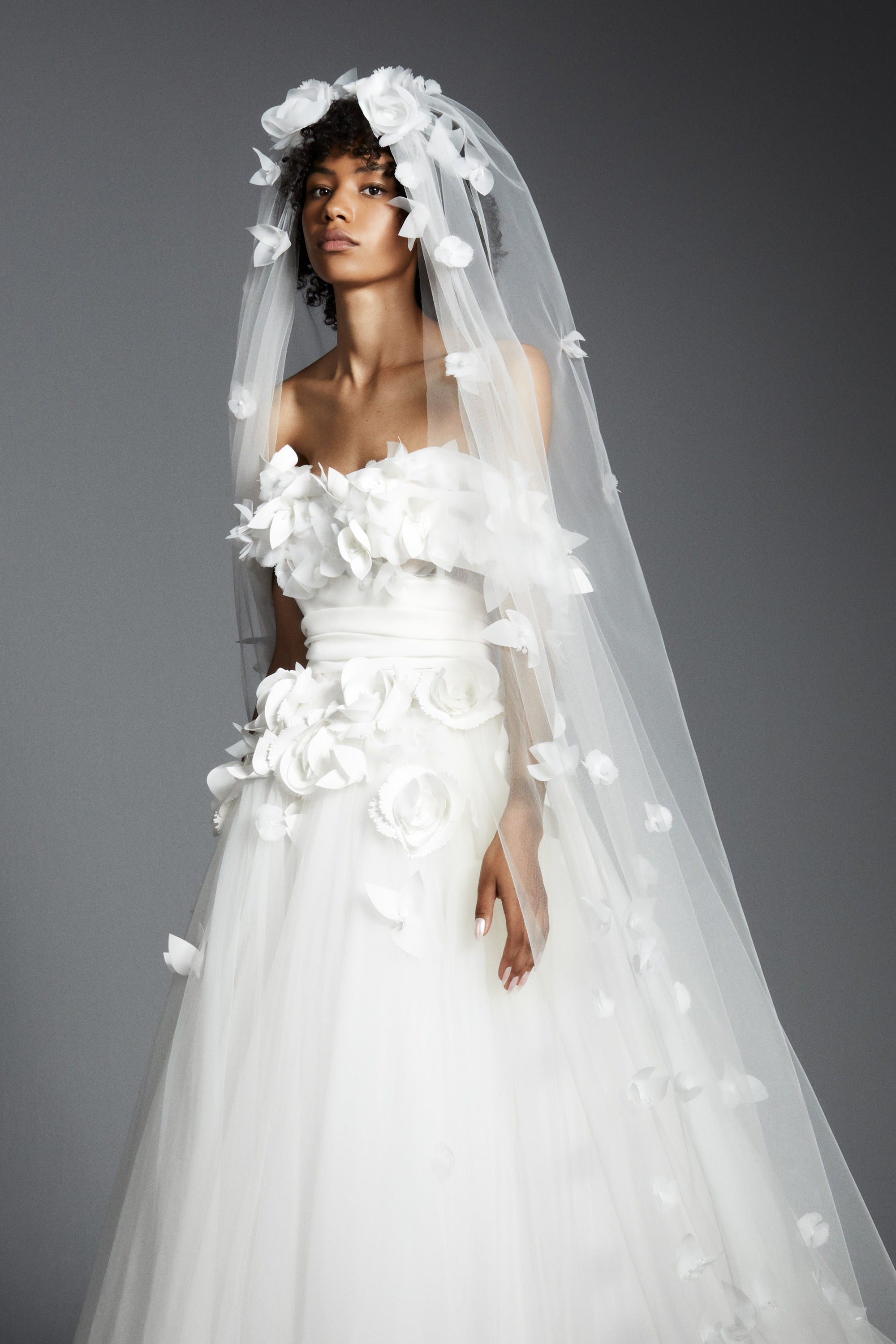 Featuring a tulle skirt paired with an airy organza bodice, this ballgown is complemented by an elegant sweetheart neckline and off-shoulder sleeves