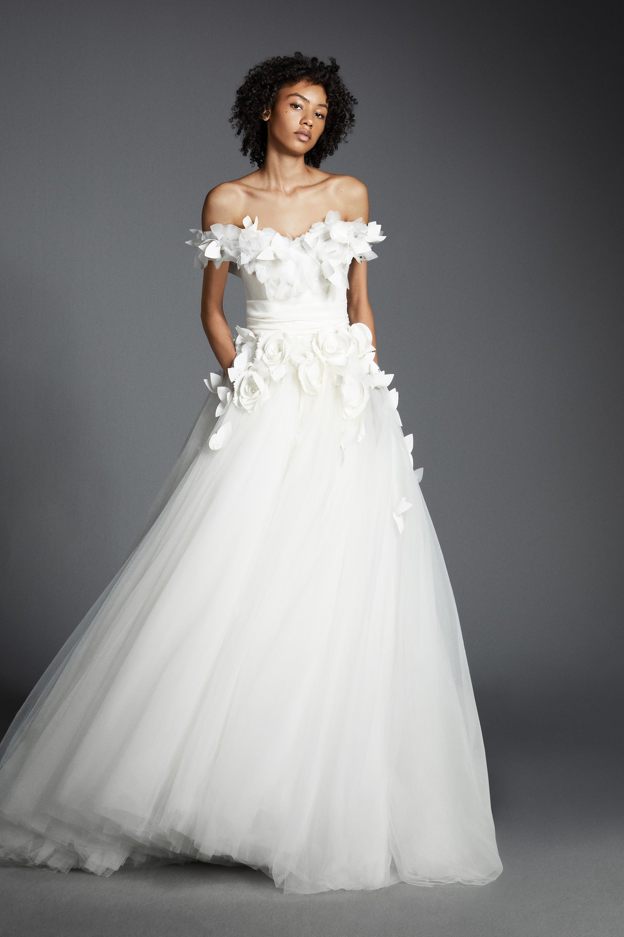 Featuring a tulle skirt paired with an airy organza bodice, this ballgown is complemented by an elegant sweetheart neckline and off-shoulder sleeves