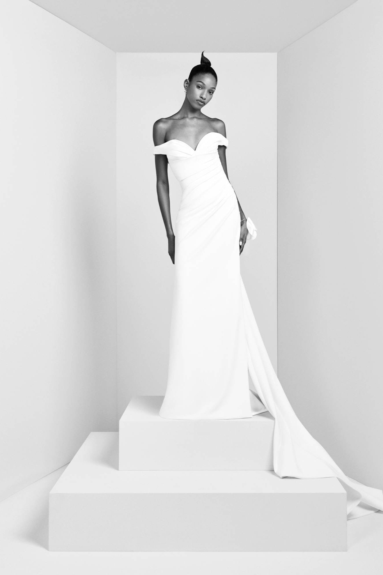 Crafted from crepe fabric with a slight stretch, this gown boasts a fitted bodice that transitions into a mermaid skirt