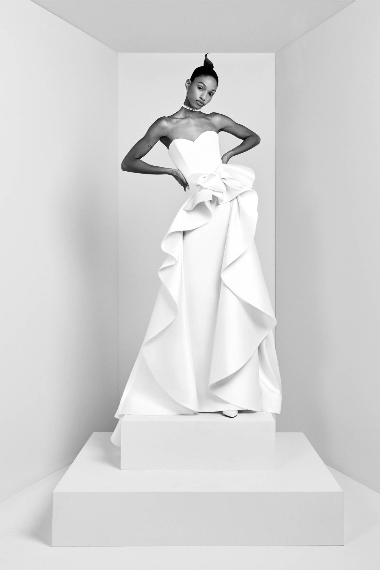 Crafted from a blend of stretch crepe and mikado, this sophisticated gown boasts a sweetheart bustier that beautifully enhances a clean column silhouette