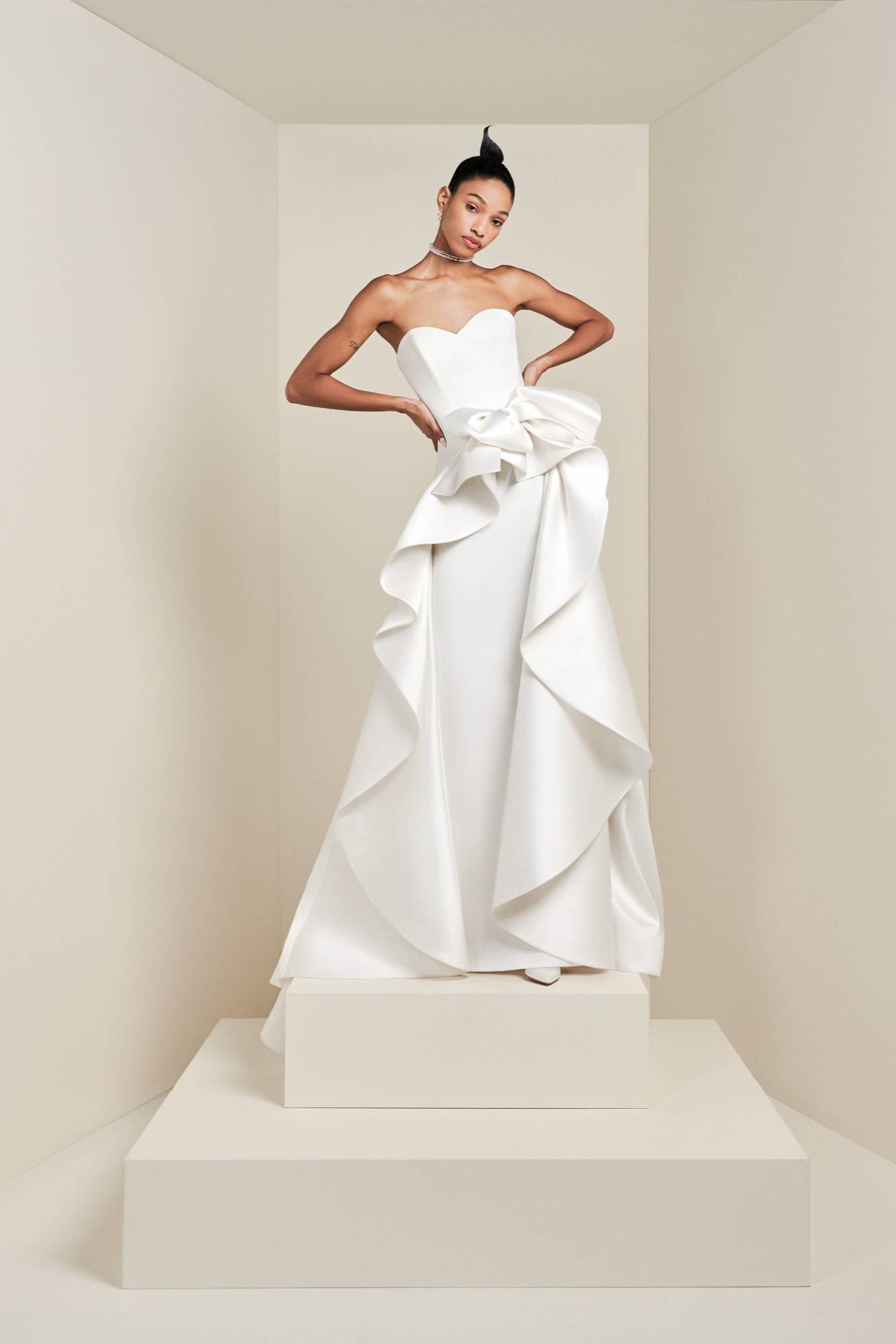 Crafted from a blend of stretch crepe and mikado, this sophisticated gown boasts a sweetheart bustier that beautifully enhances a clean column silhouette