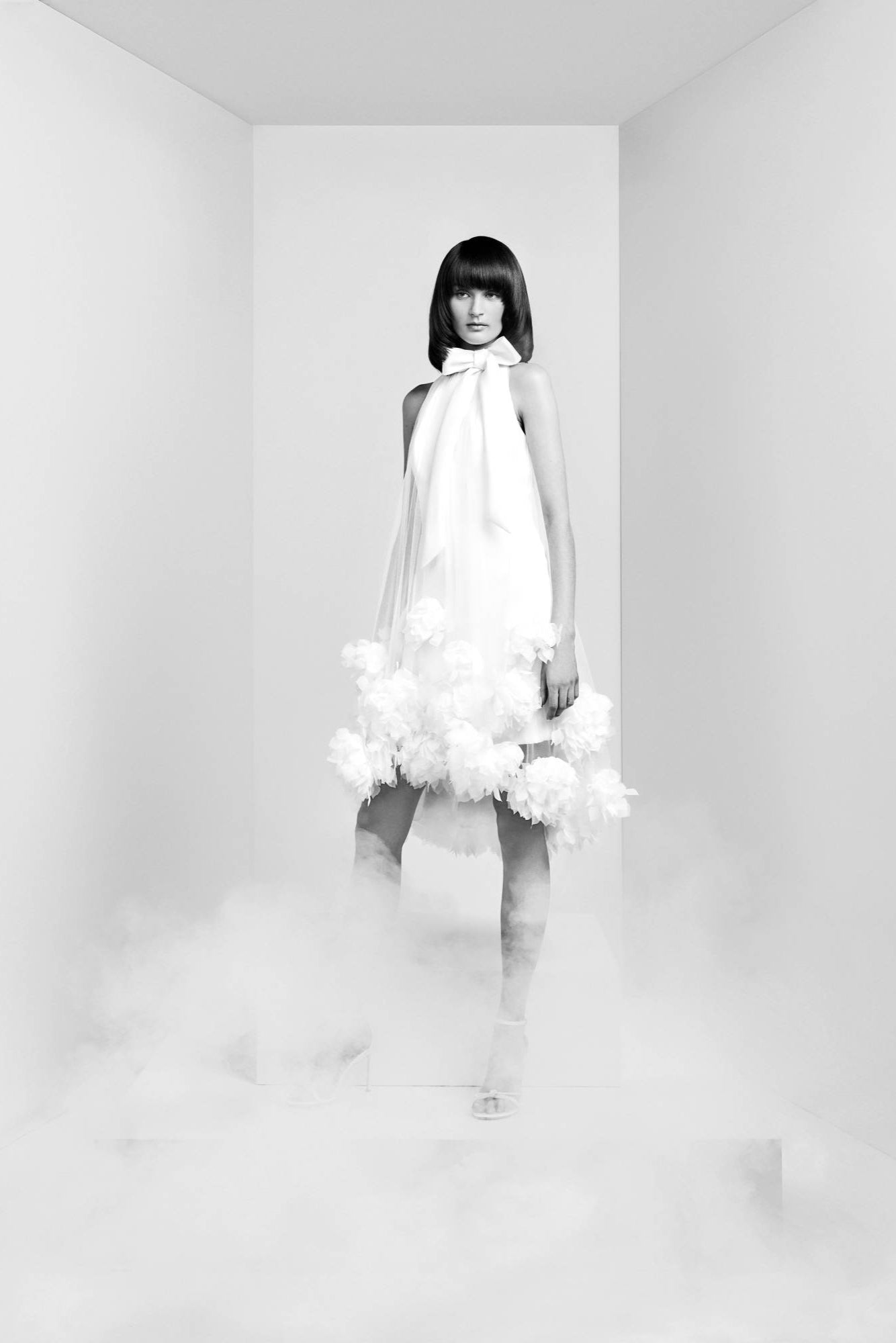 This short dress is crafted from matte satin fabric, overlaid with a romantic tulle sheath dress