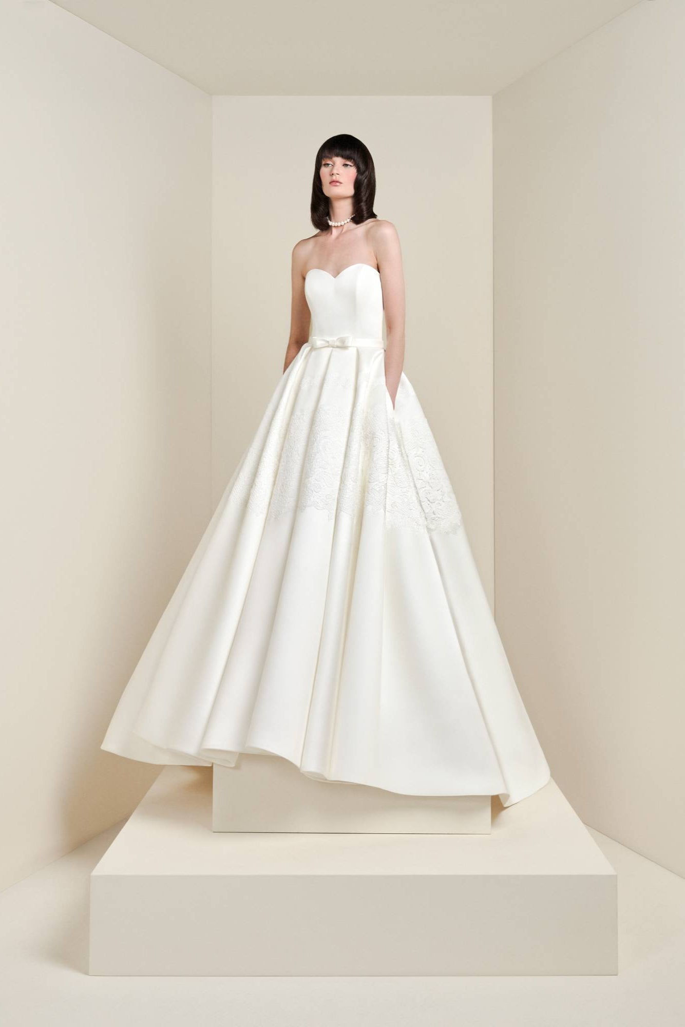 This a-line gown is meticulously crafted from satin fabric adorned with delicate lace em-bellishments