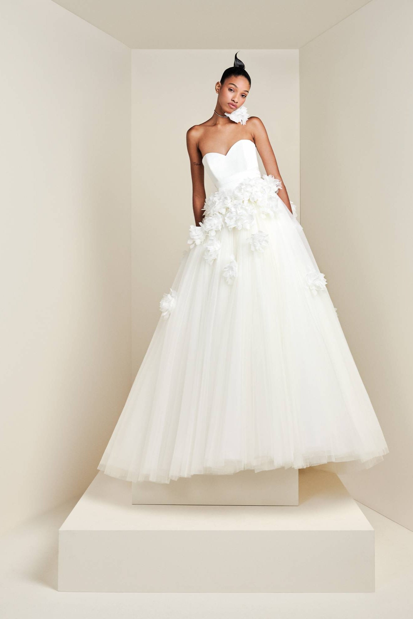 Featuring a matte satin bodice with a sweetheart bustier, this romantic tulle gown is cinched at the waist with a draped organic taffeta belt