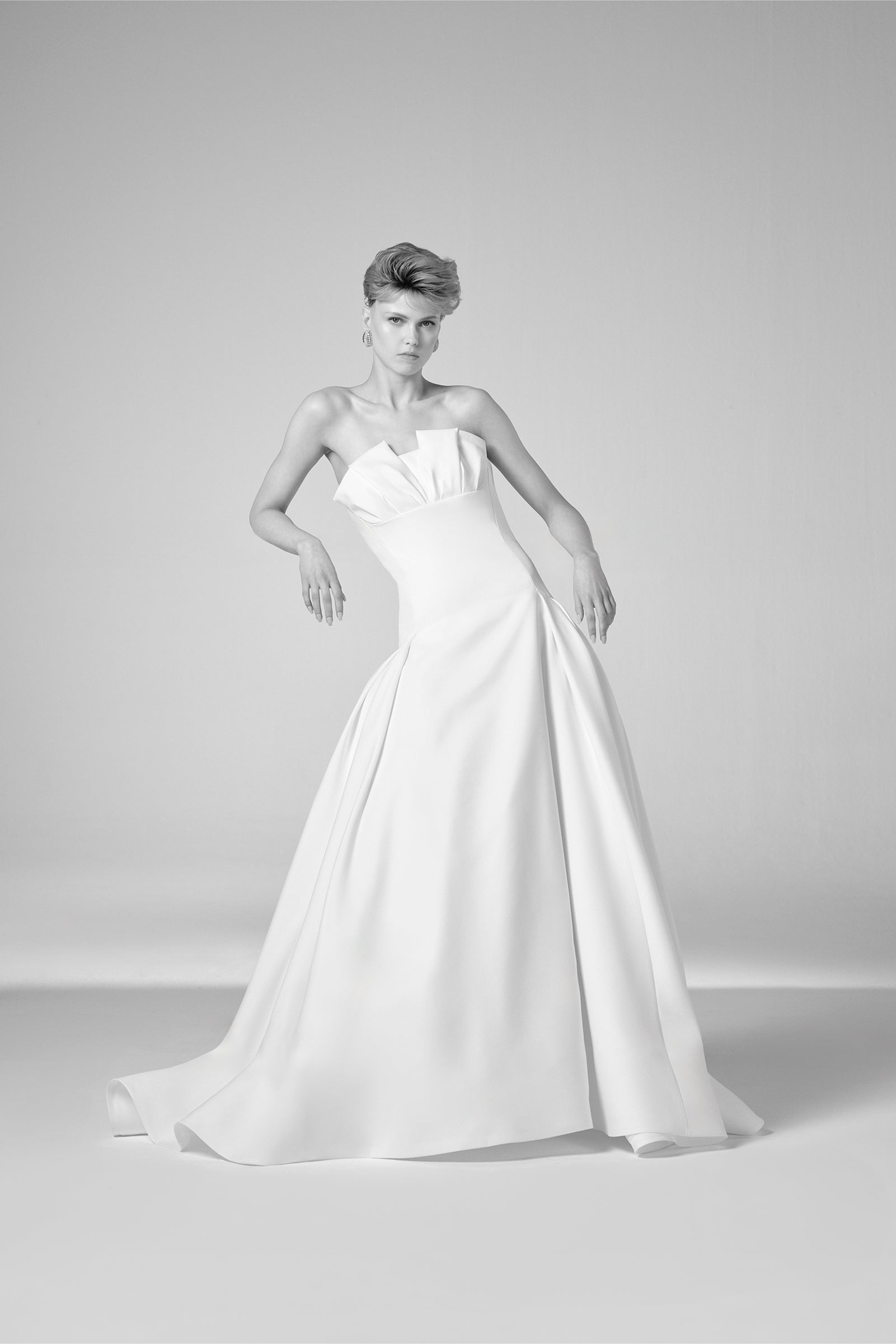 This strapless light mikado gown features a beautifully draped bustier, flowing effortlessly into a voluminous a-line skirt, from the Viktor&Rolf Mariage collection.
