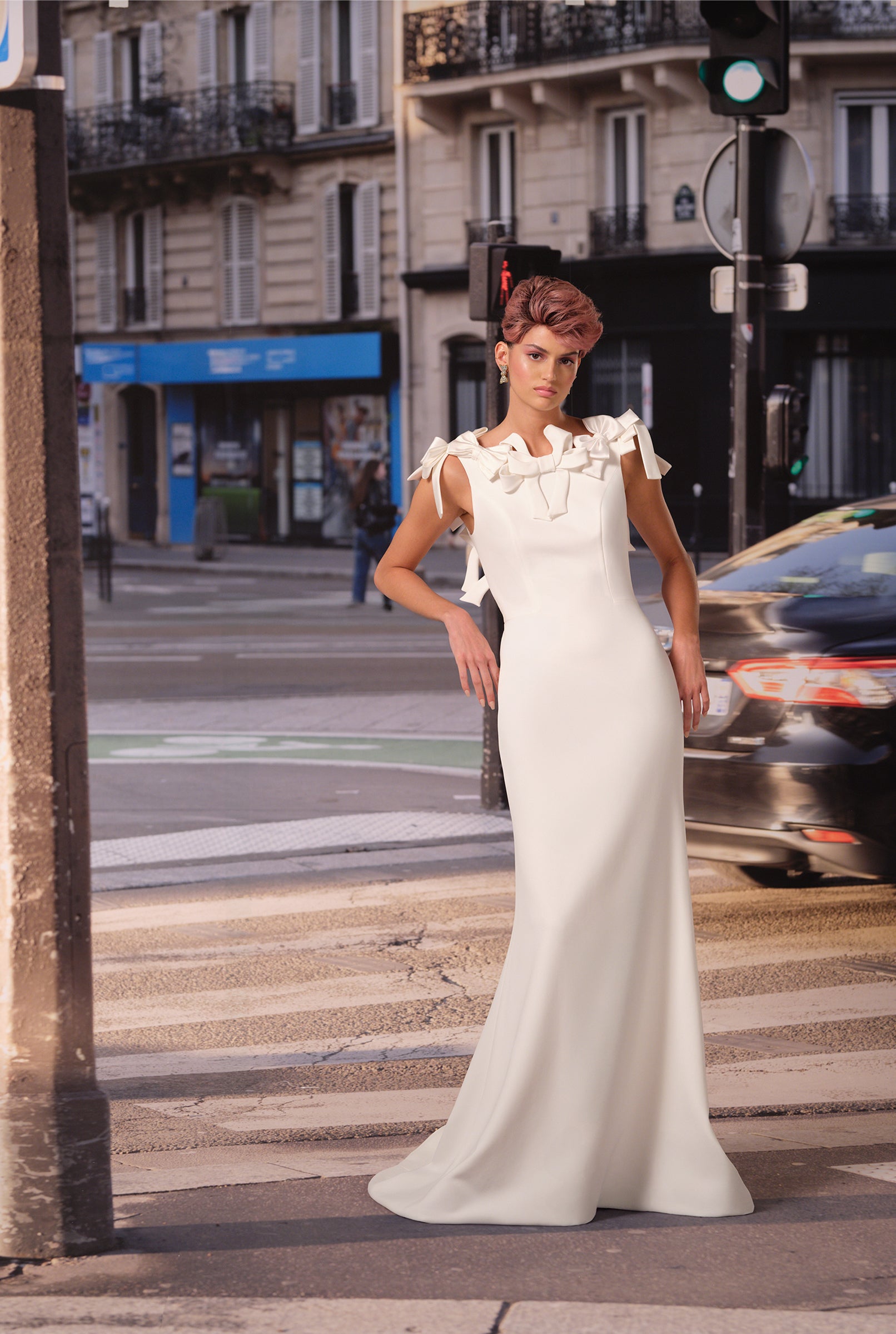 This refined mermaid gown in stretch crepe is adorned with a cascade of couture bows, framing the open sabrina neckline and plunging back, from the Viktor&Rolf Mariage collection.