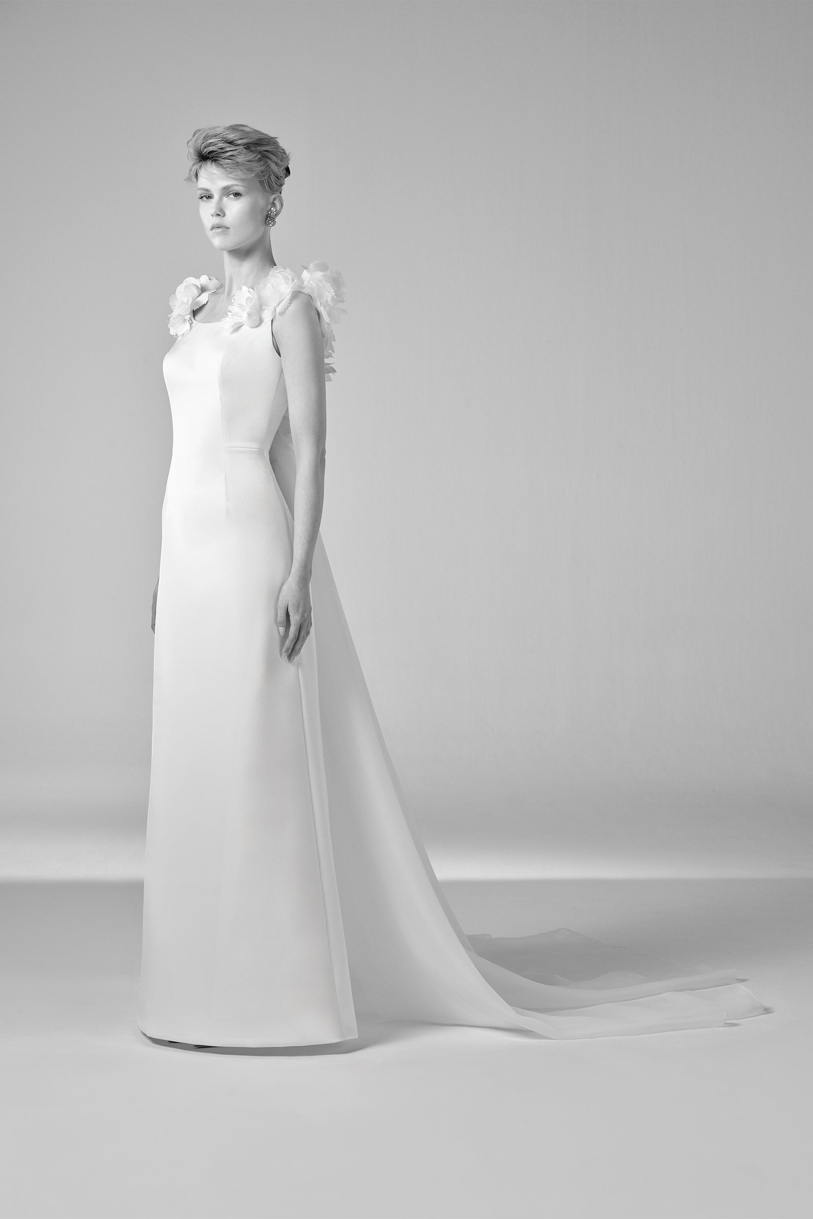 This elegant double crepe column gown is elevated by a detachable organza watteau train that adds dramatic flair, from the Viktor&Rolf Mariage collection.