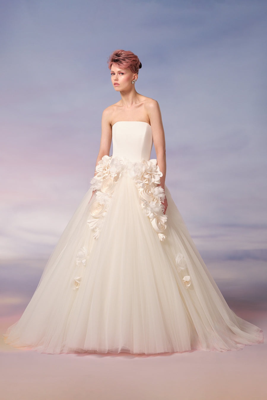 This strapless ball gown features a sleek stretch crepe strapless bodice, and  a dramatically voluminous tulle skirt, from the Viktor&Rolf Mariage collection.