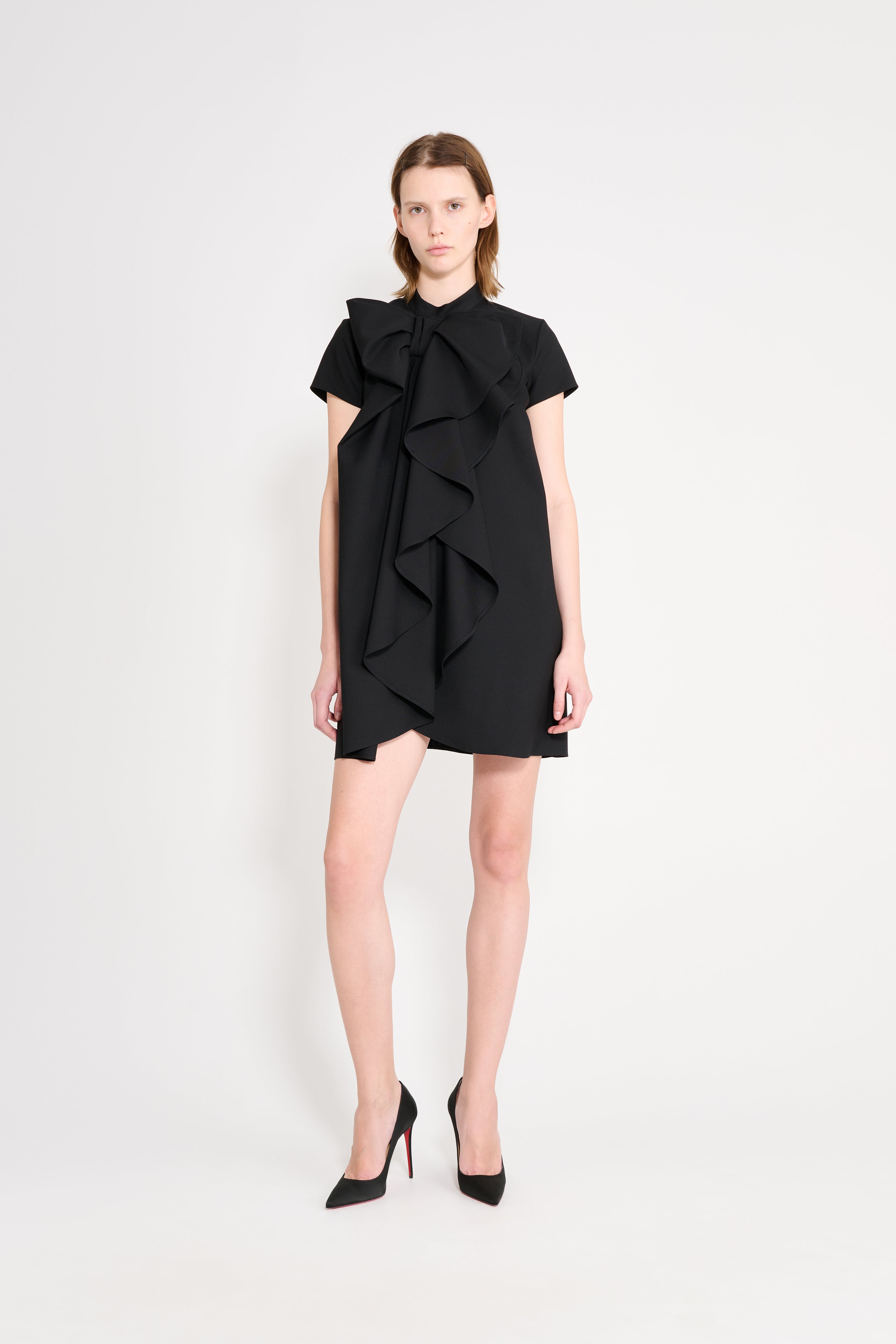 Model wearing a black dress.