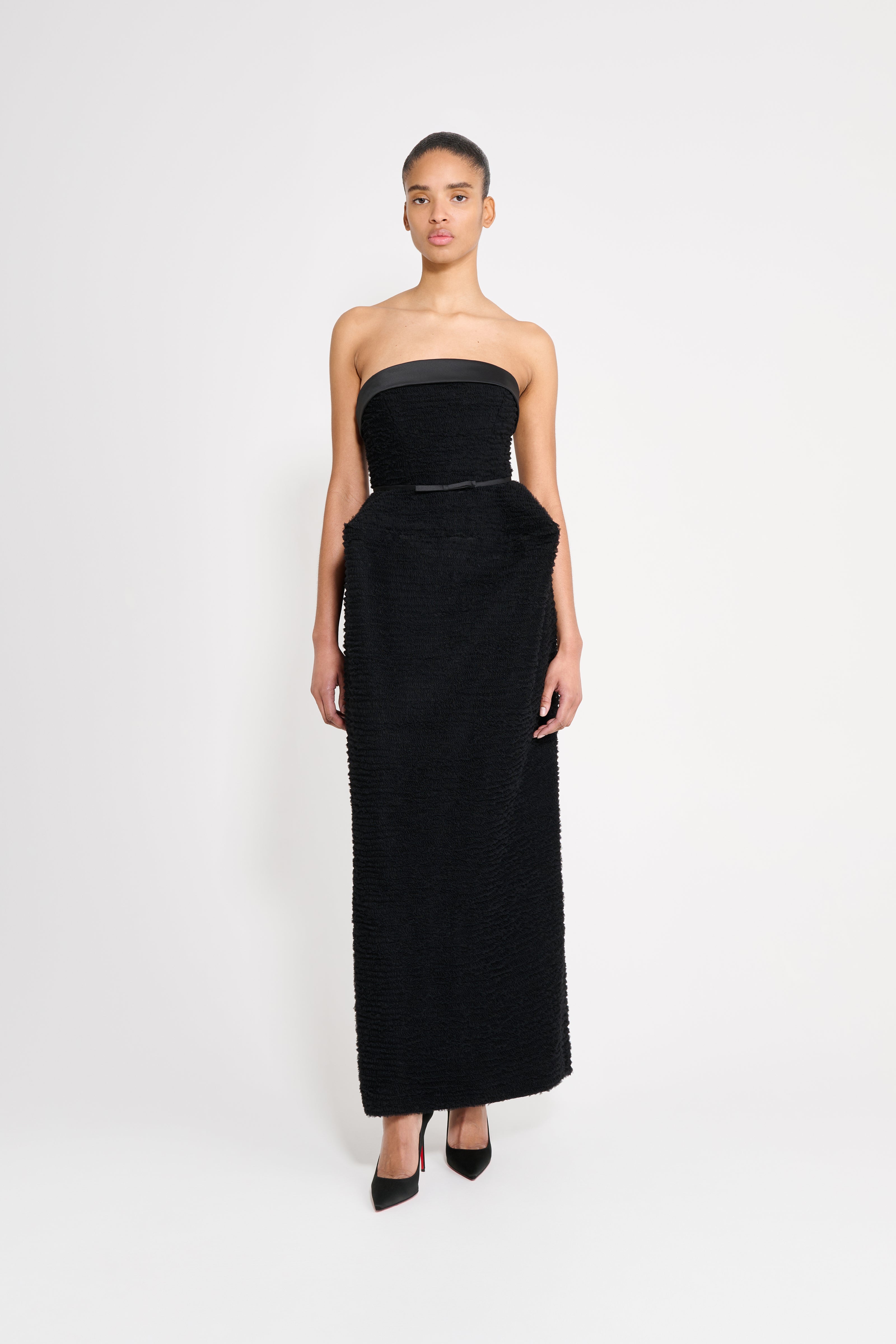 Model wearing a black dress.