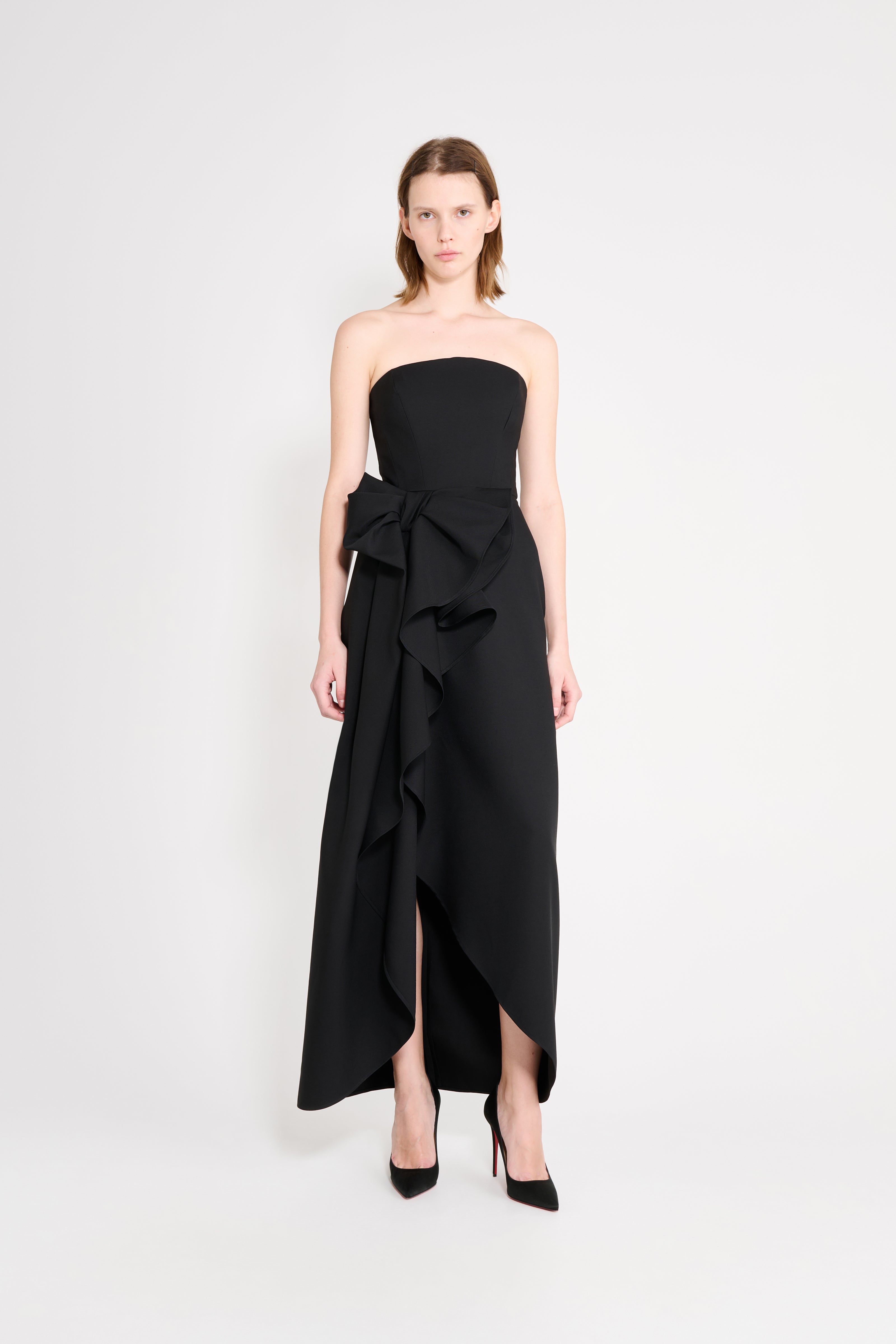 Black strapless dress with a bow detail on a white background