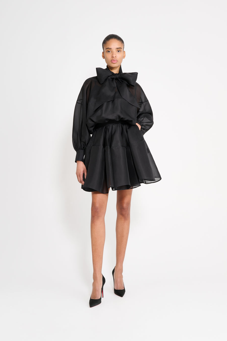 Model wearing a black dress.