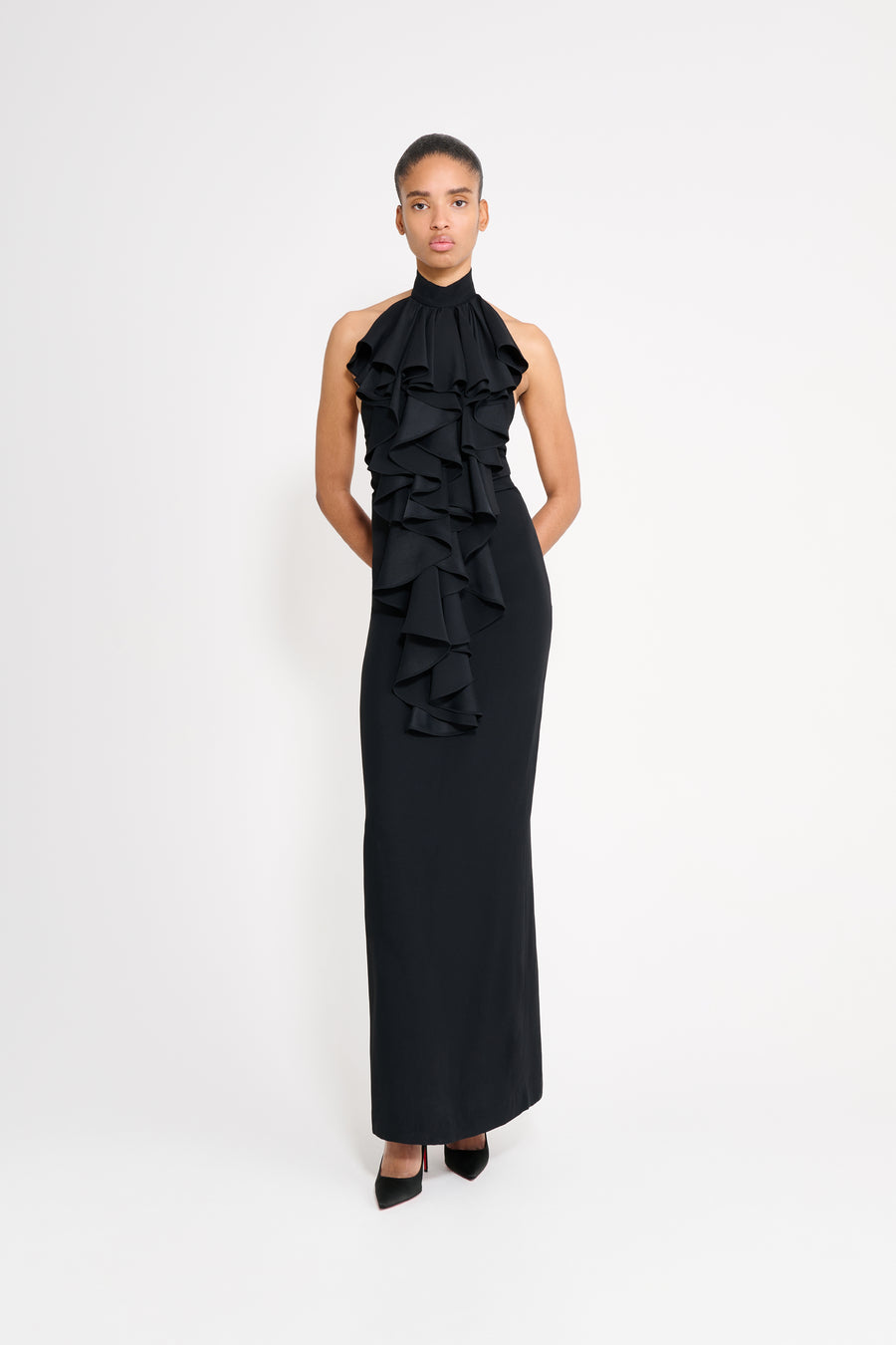 Woman wearing a black ruffled dress on a white background