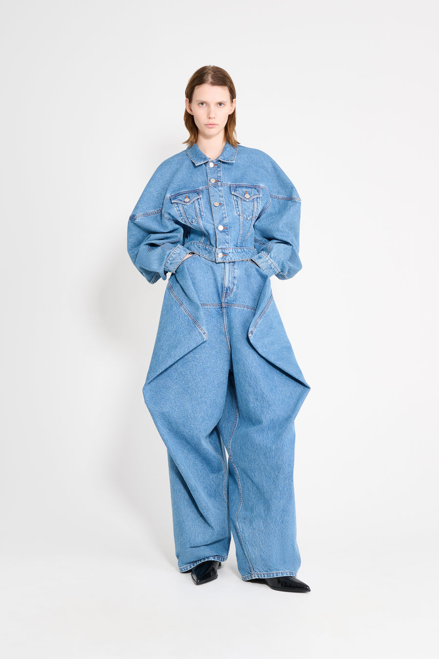 Person wearing a blue denim outfit on a white background