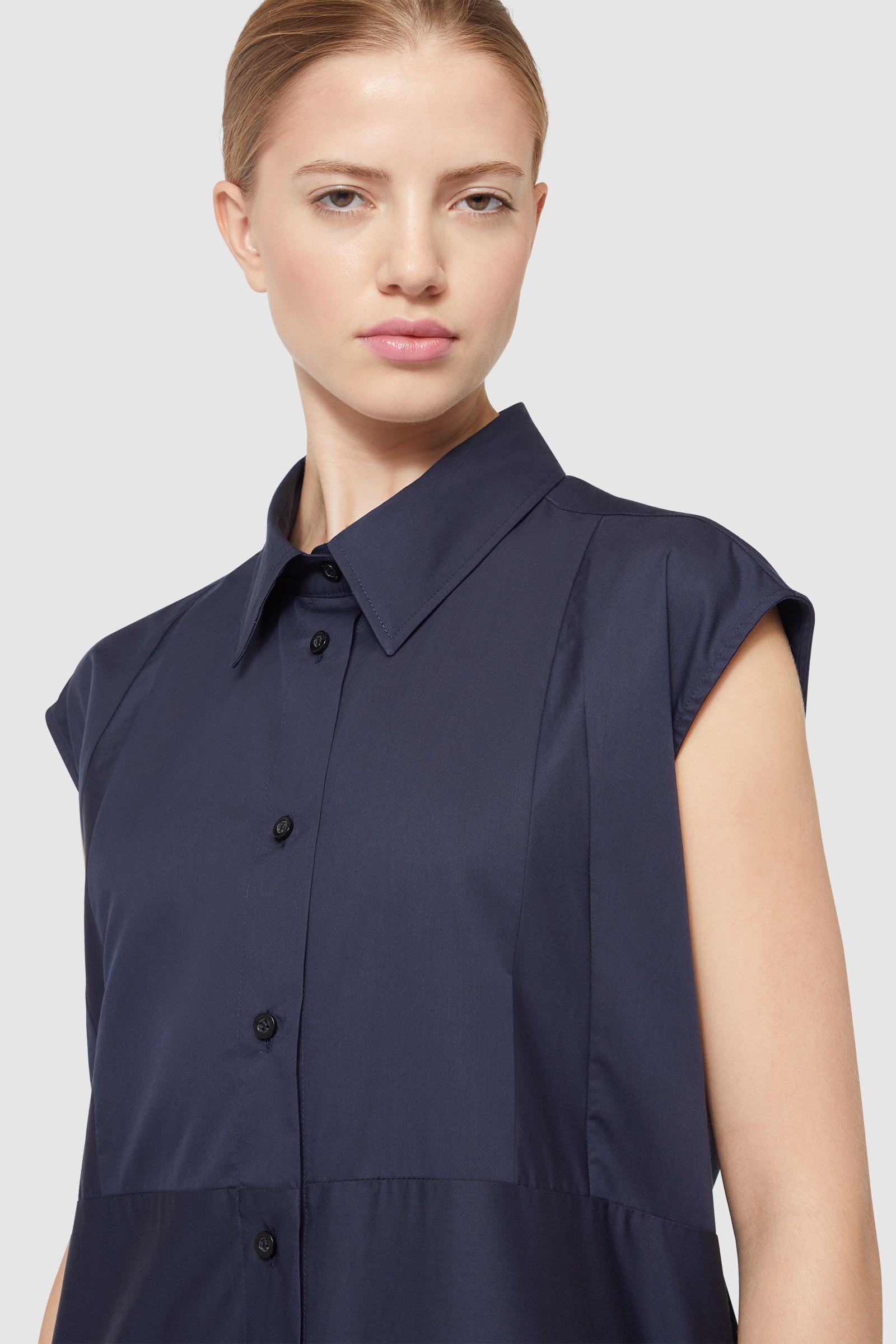 Navy short-sleeve dress with a structured collar and button-down front, crafted from smooth fabric for a sleek look.