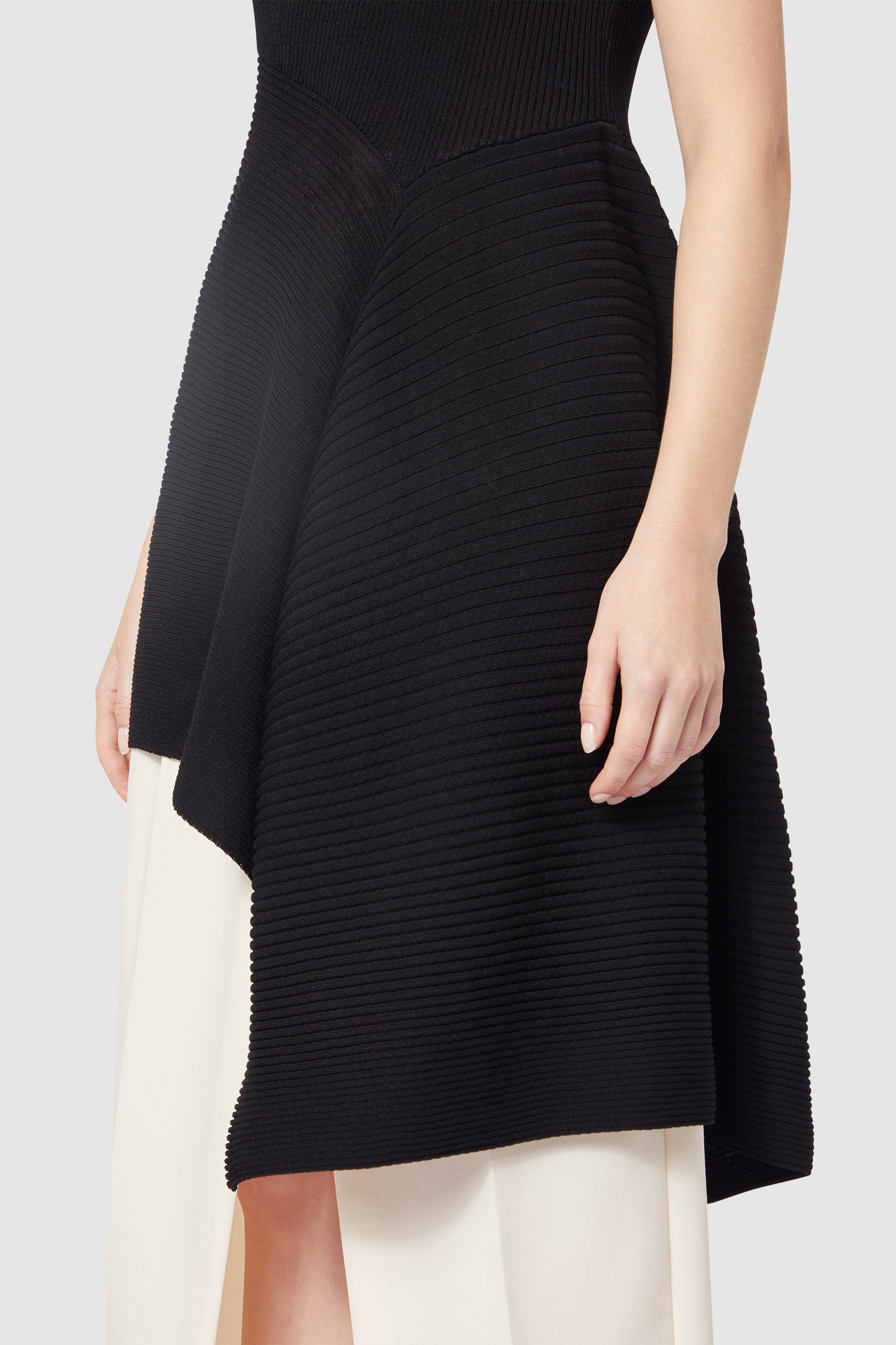 Asymmetrical dress with ribbed black knit bodice, contrasted elegantly with flowing ivory fabric underneath.
