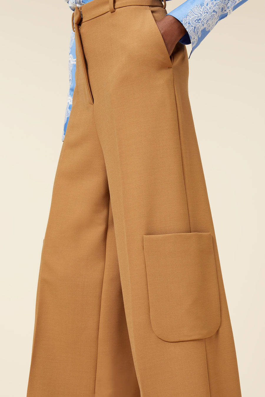 High-waisted camel wide-leg trousers with tailored pockets, perfectly paired with a light blue lace-detailed blouse.