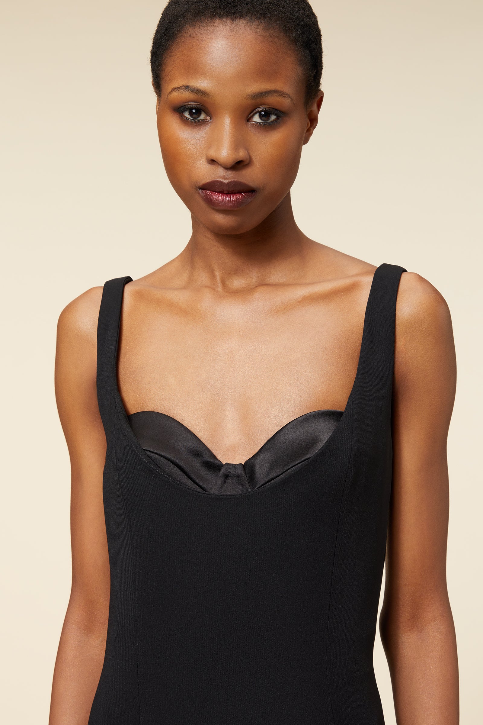 Elegant black dress featuring a satin sweetheart neckline, offering a sophisticated and minimalist design.