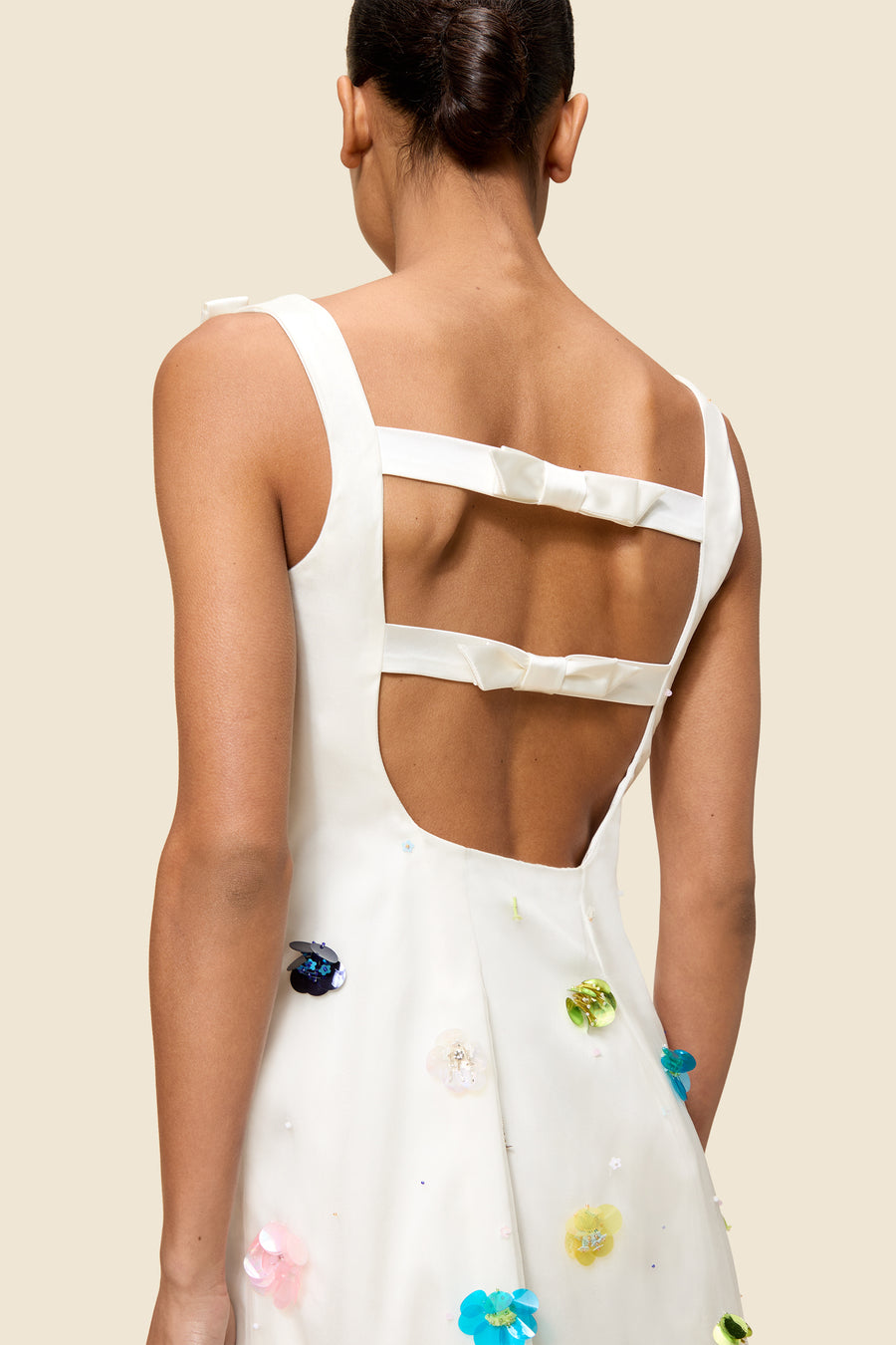 With hand-applied paillettes and crystals on silk organza featuring the satin edges, the dress transforms classic floral embroidery into a modern piece