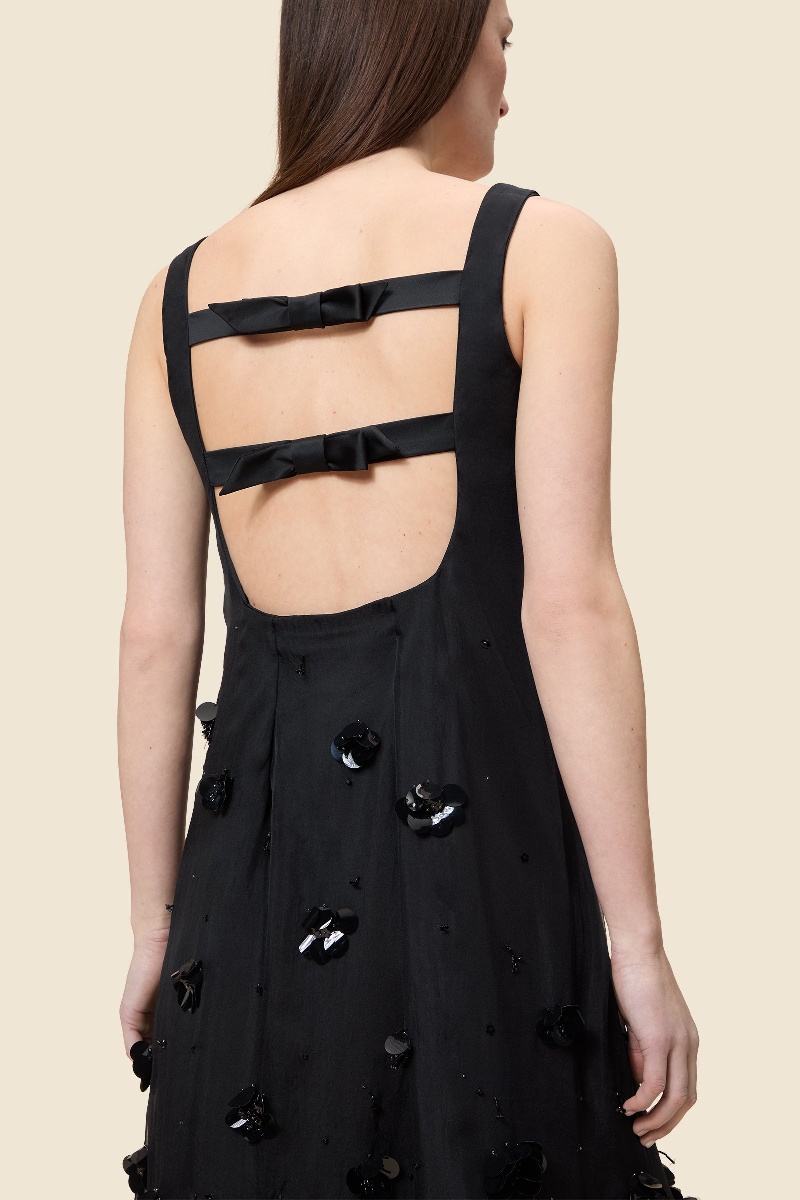 With hand-applied paillettes and crystals on silk organza featuring the satin edges, the dress transforms classic floral embroidery into a modern piece