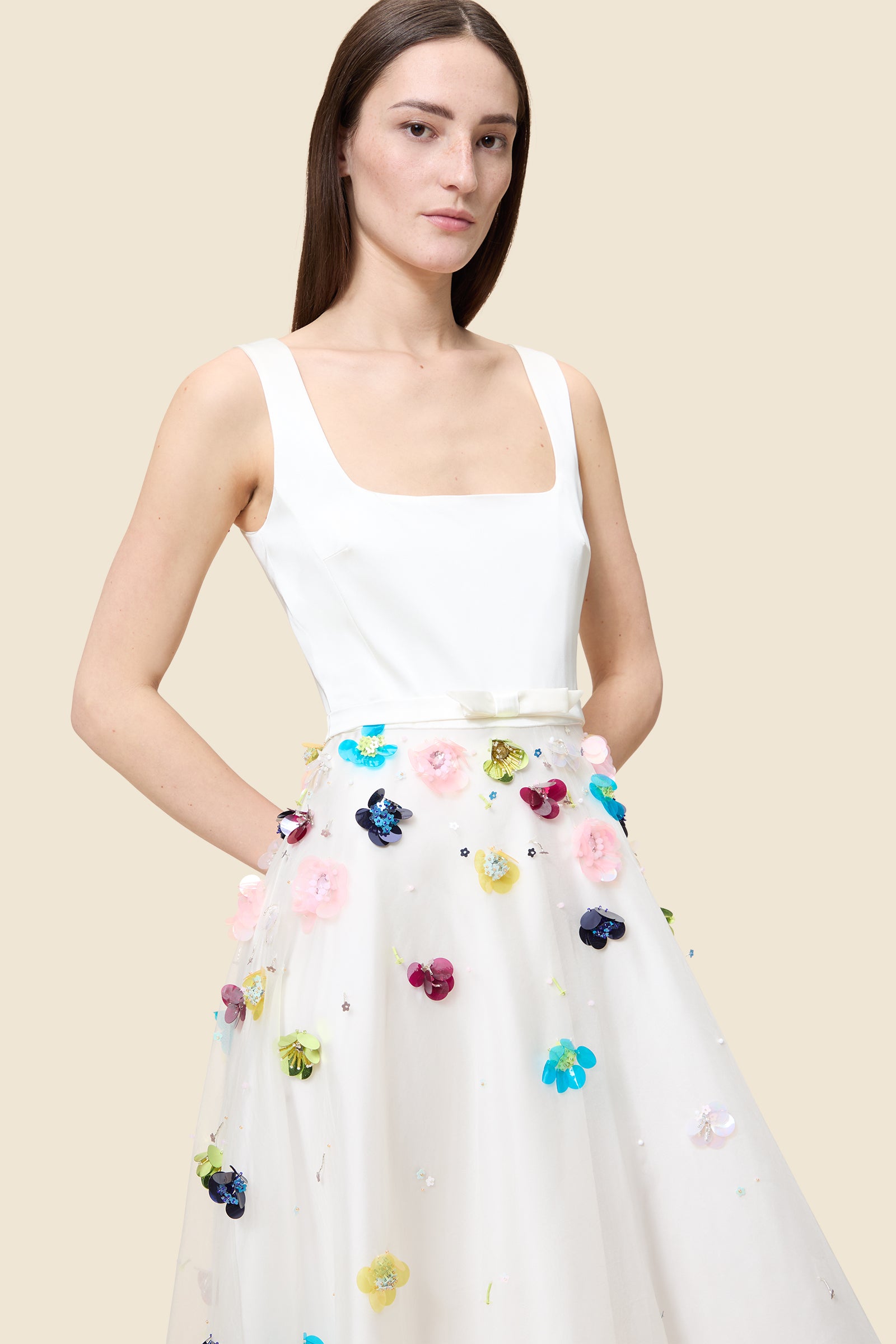 With hand-applied paillettes and crystals on silk organza featuring the satin edges, the dress transforms classic floral embroidery into a modern piece