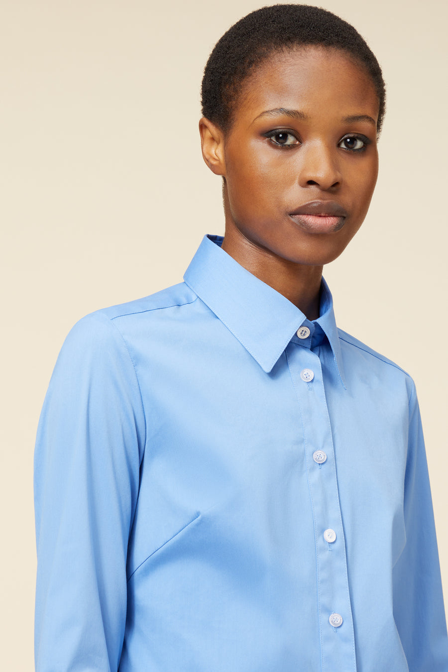 Elegant sky blue cotton shirt with classic collar and button-up front, tailored for a polished and sophisticated look.