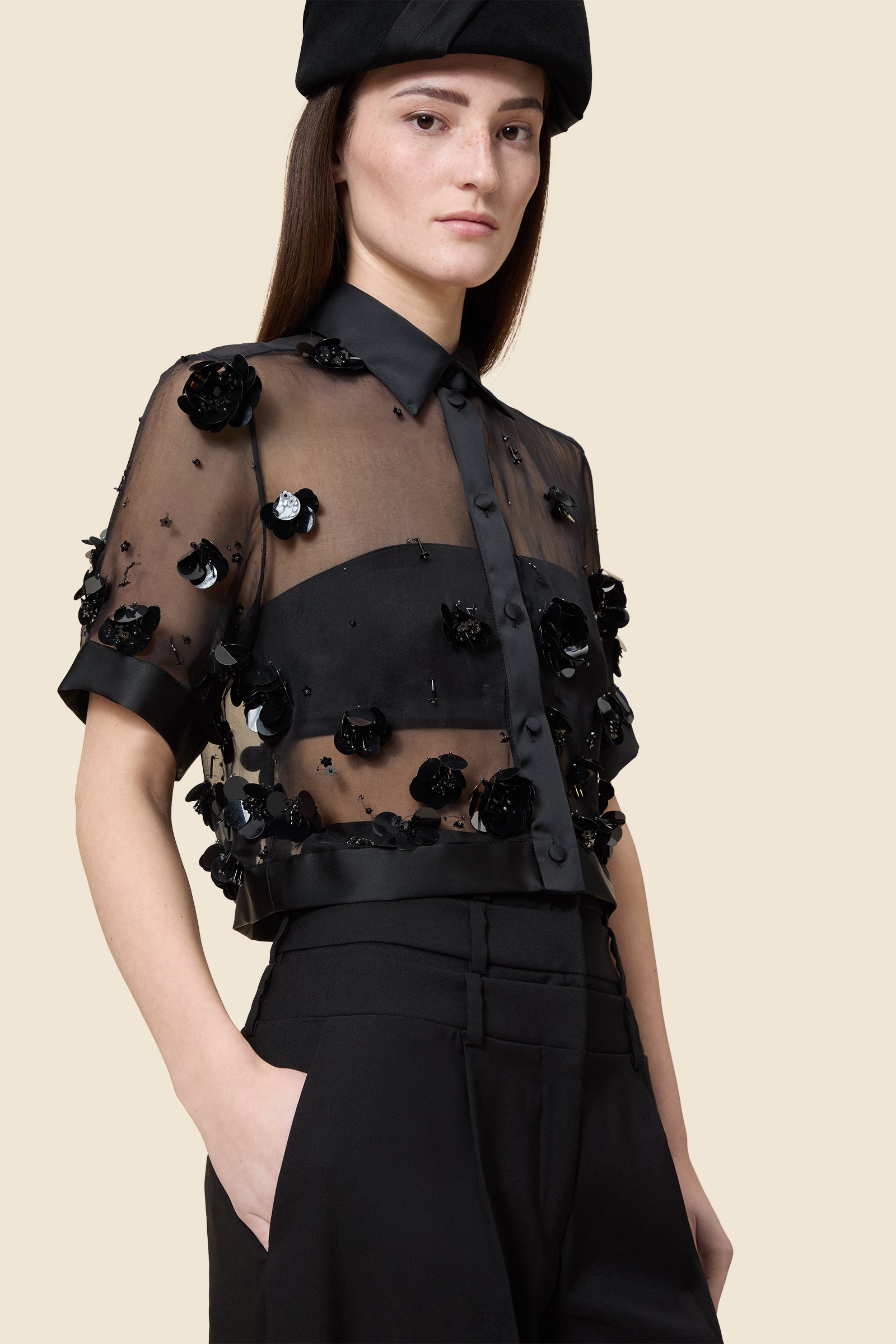 With hand-applied paillettes and crystals on silk organza featuring the satin edges, the top transforms classic floral embroidery into a modern piece
