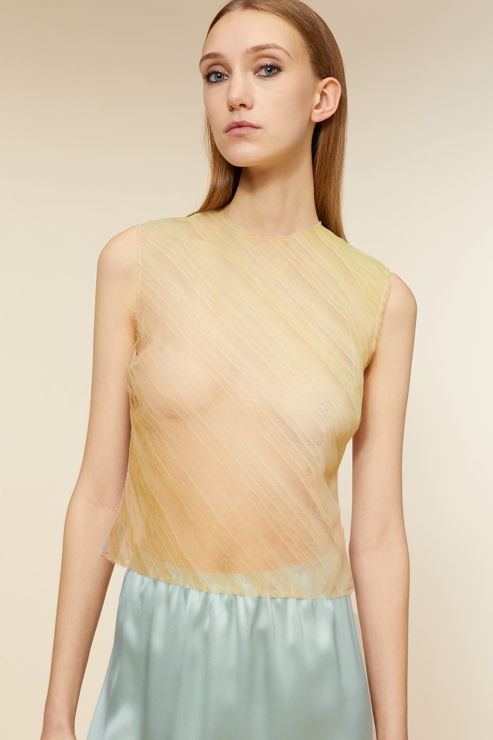 Crafted with delicate haute couture-inspired tulle, the top captures the essence of dreamlike elegance with subtle fabric movement